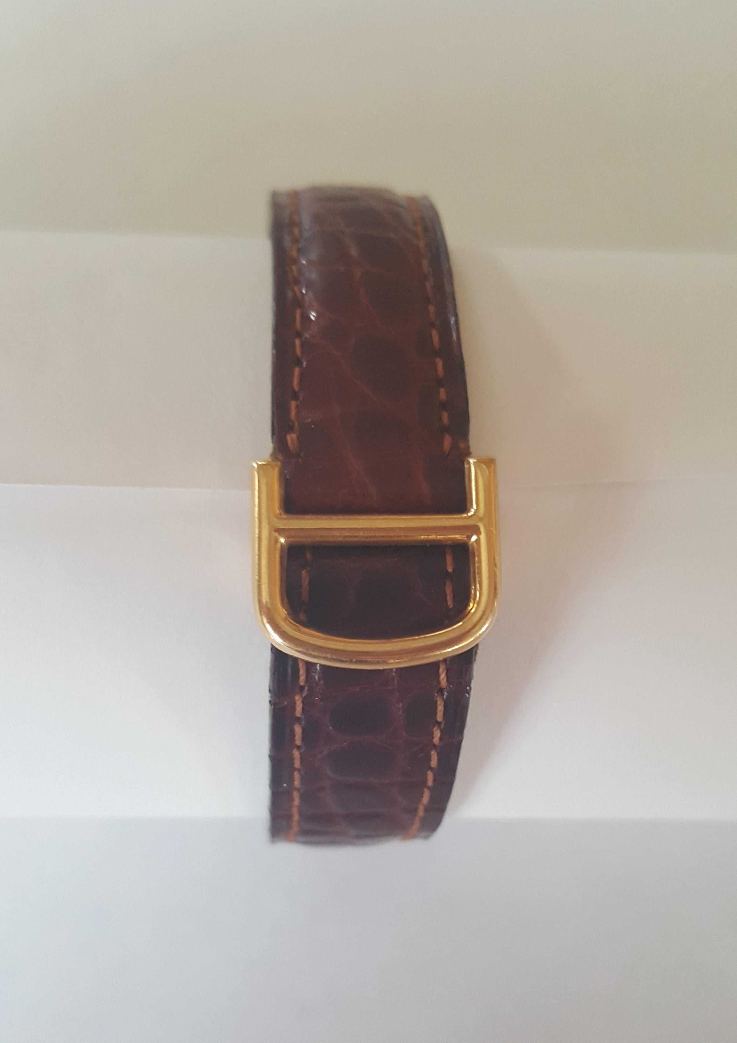 Solid 18kt Yellow Gold Cartier Tank Watch, 031795, France, Leather, 17 Jewel.  The watch has been oiled, cleaned and in working condition. Very good condition, white face, black roman numerals. Blue cabochon sapphire crown. Stamped 18kt Cartier,