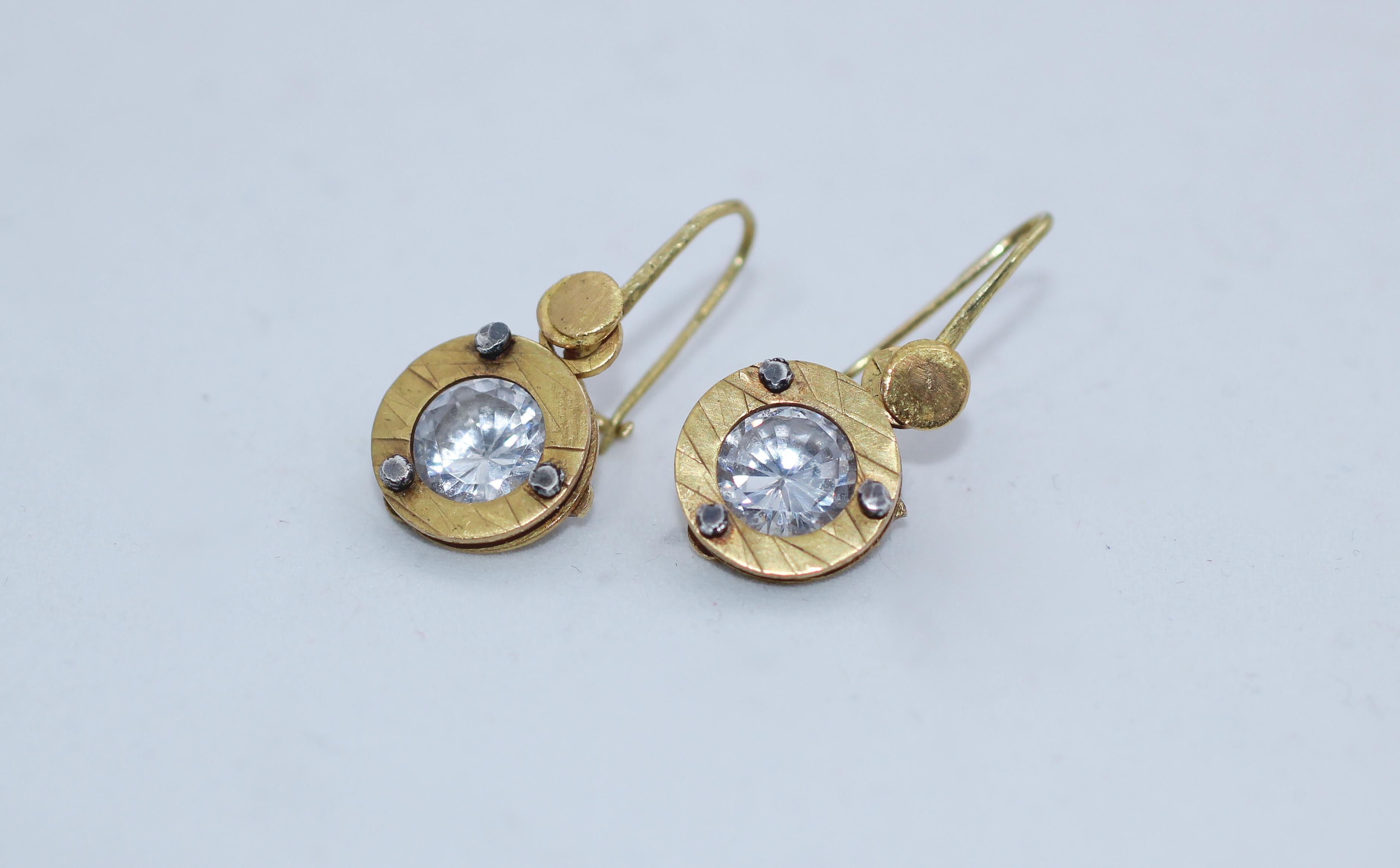 Brilliant Dangle Drop Earrings. Brilliant cut white natural Zircons are set in textured 21K gold. This simple design brings together many elements - industry, constructivism, and manual craftsmanship. The surface is textured to compliment the