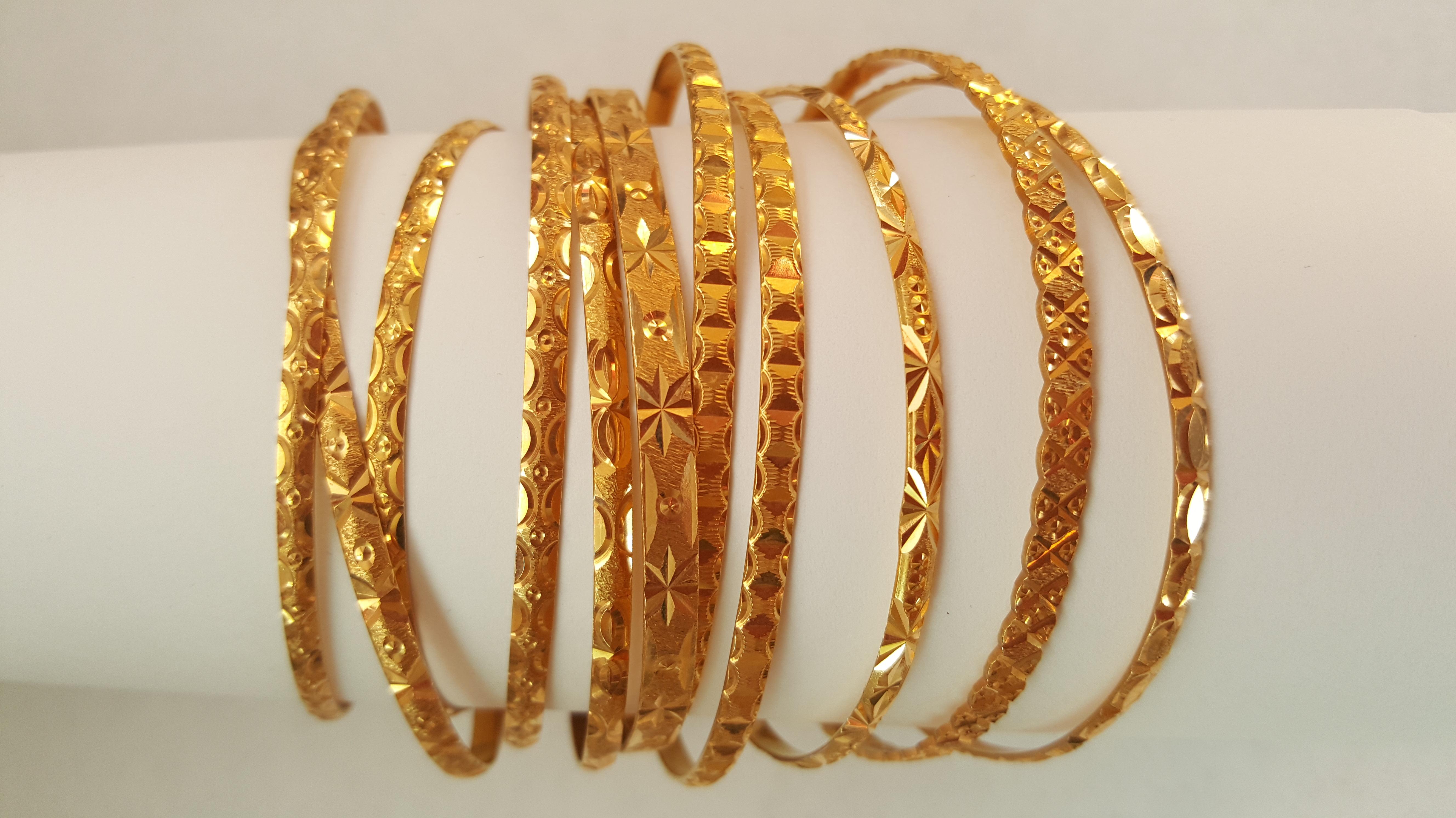 Solid 21kt Gold Bangles, Set of 11, Very Good Condition, Diamond Cut Engraving. These are beautiful bracelets with unique diamond-cut designs. If you want to see more images, please let us know. Ten of the bracelets are standard adult size. One of