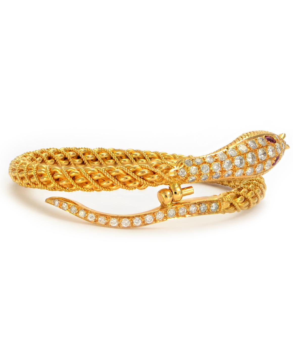 Excellent condition! This solid 22K yellow gold textured bangle features 46 genuine diamonds throughout the head and tail and two oval genuine ruby eyes. The diamonds are F-G in color and SI2-I1 in clarity. The bangle clasps at the head and tail.