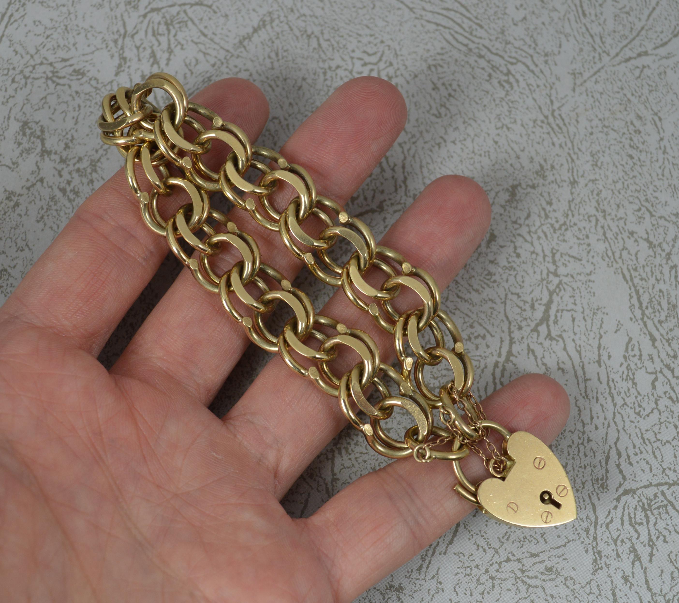 A superb vintage bracelet.
A heavy 9 carat gold example.
9ct yellow gold, double eight shaped curb links. Complete with padlock and safety chain.

CONDITION ; Very good for age. Working clasp. Crisp design. Issue free. Please view