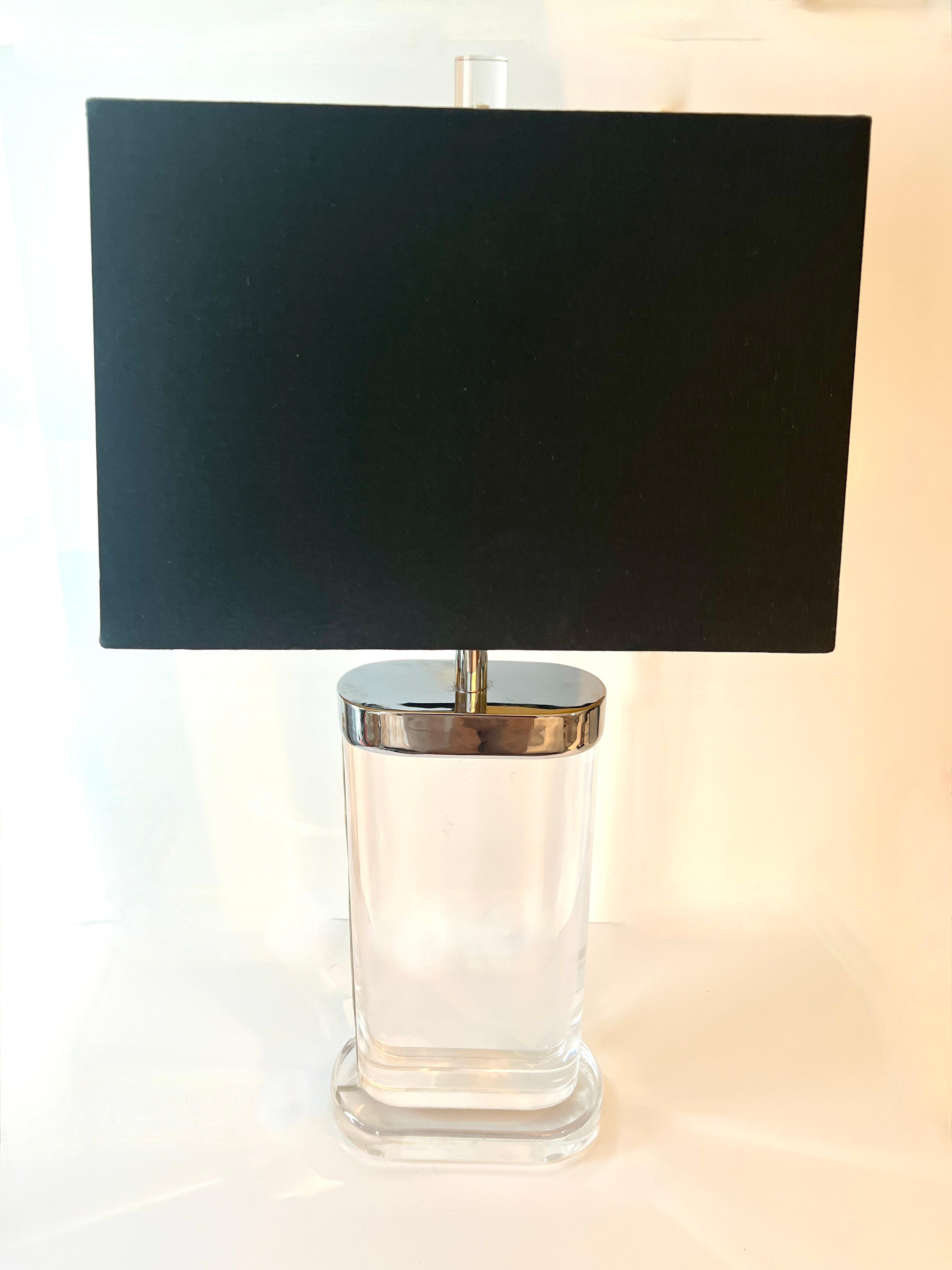 A spectacular and very heavy, solid acrylic / lucite table lamp with Chrome cap, adjustable rod and two sockets.  The center rod adjusts two inches taking the height to 36