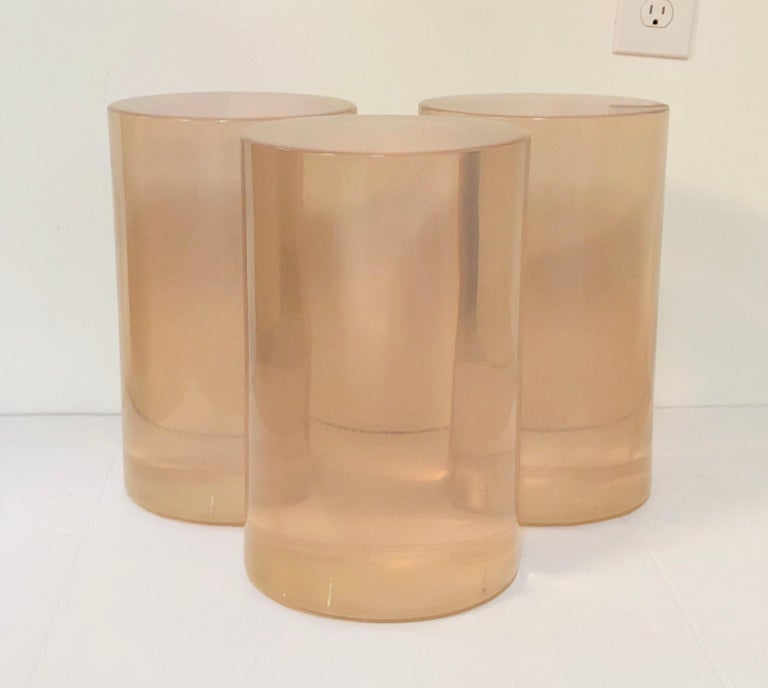A solid acrylic resin drink or side table. Each one is 9