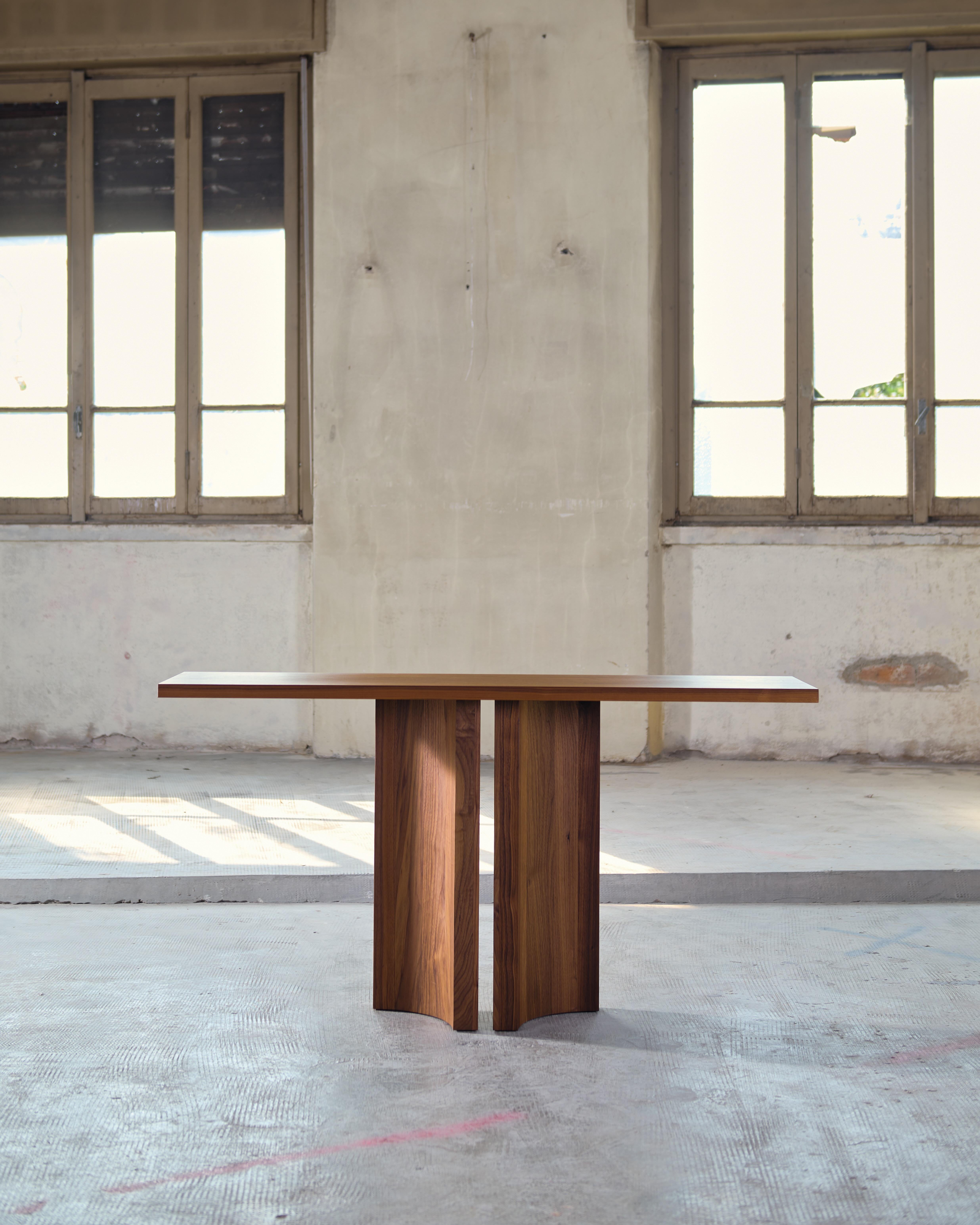 Inspired by light breaking through narrow voids in architectural structures, Aperta features a precise slit, creating a sense of lightness to its solid form. 

The Aperta Console has manually adaptable legs, allowing for various distinct