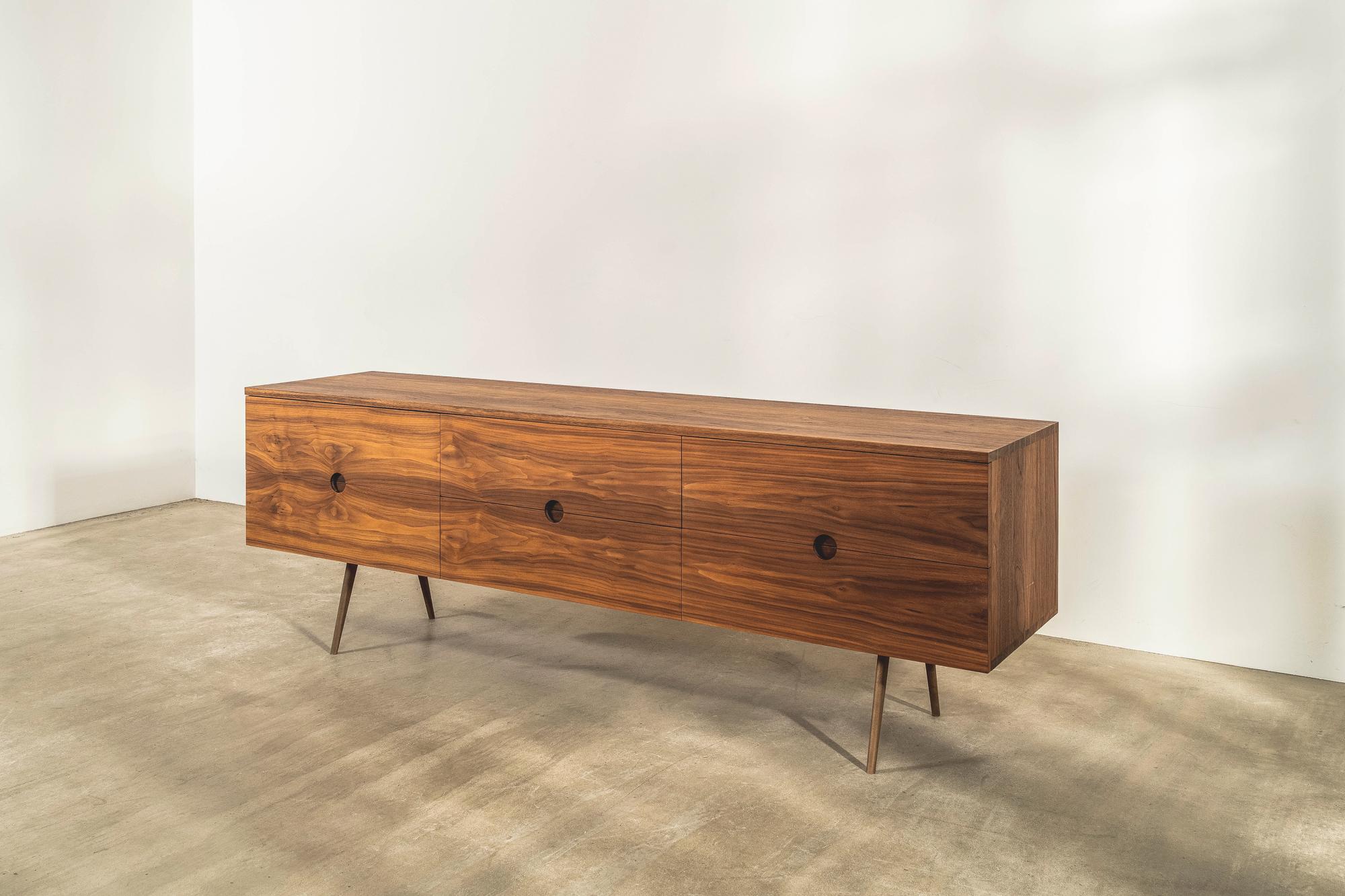 This special edition sideboard with solid brass underframe has six drawers and is made in solid walnut with an oiled finish. 

It has traditional finger jointing detail on the top and bottom edges and carefully considered detailing for the drawer