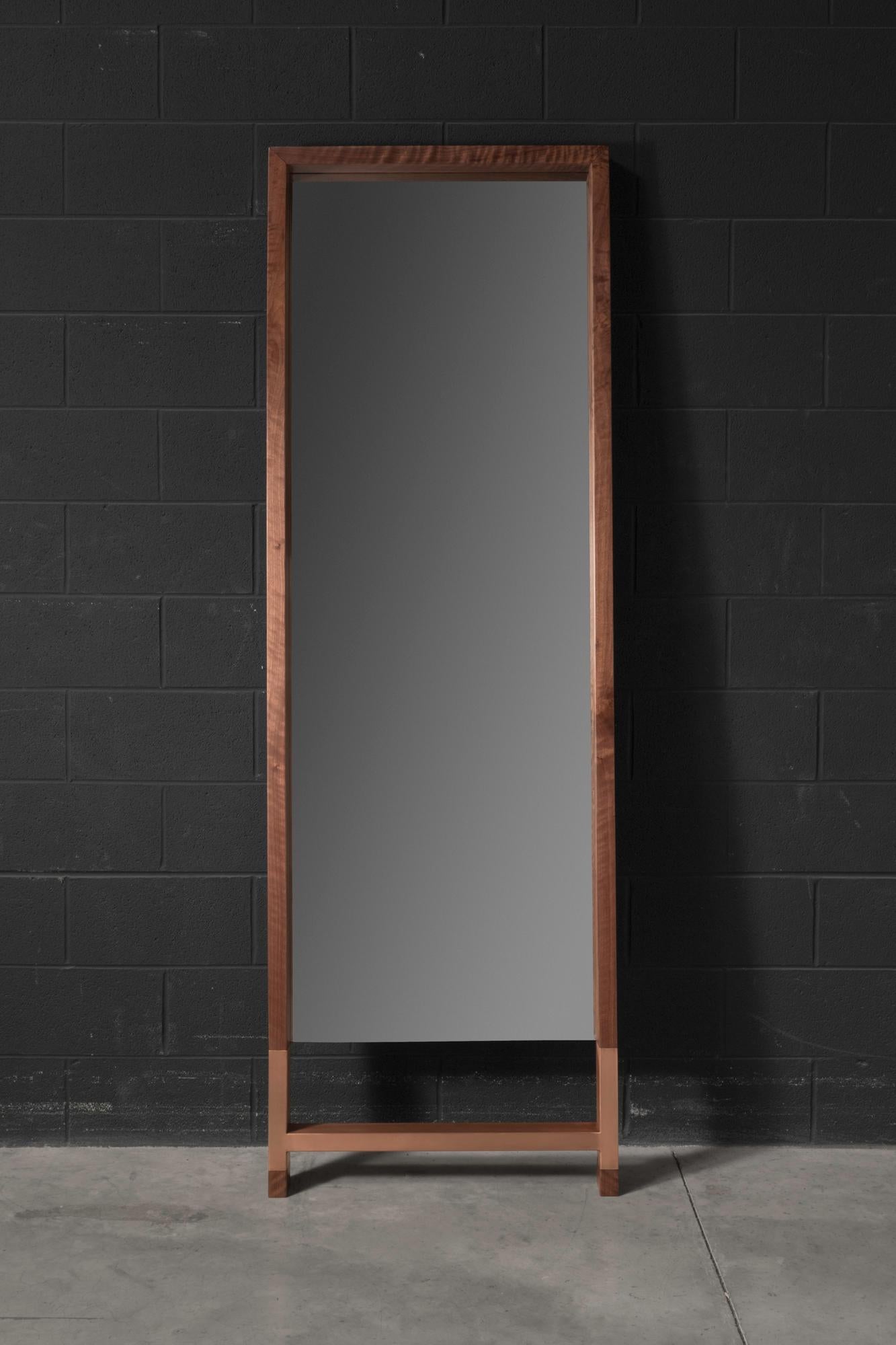 The Madison standing mirror is made of solid American walnut with a copper-plated metal base. The way the tones of the copper and walnut enhance one another makes the Madison standing mirror stand out as a modern and sleek mirror that will fit many