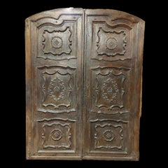 Solid and baroque double-leaf walnut entrance door, Italy