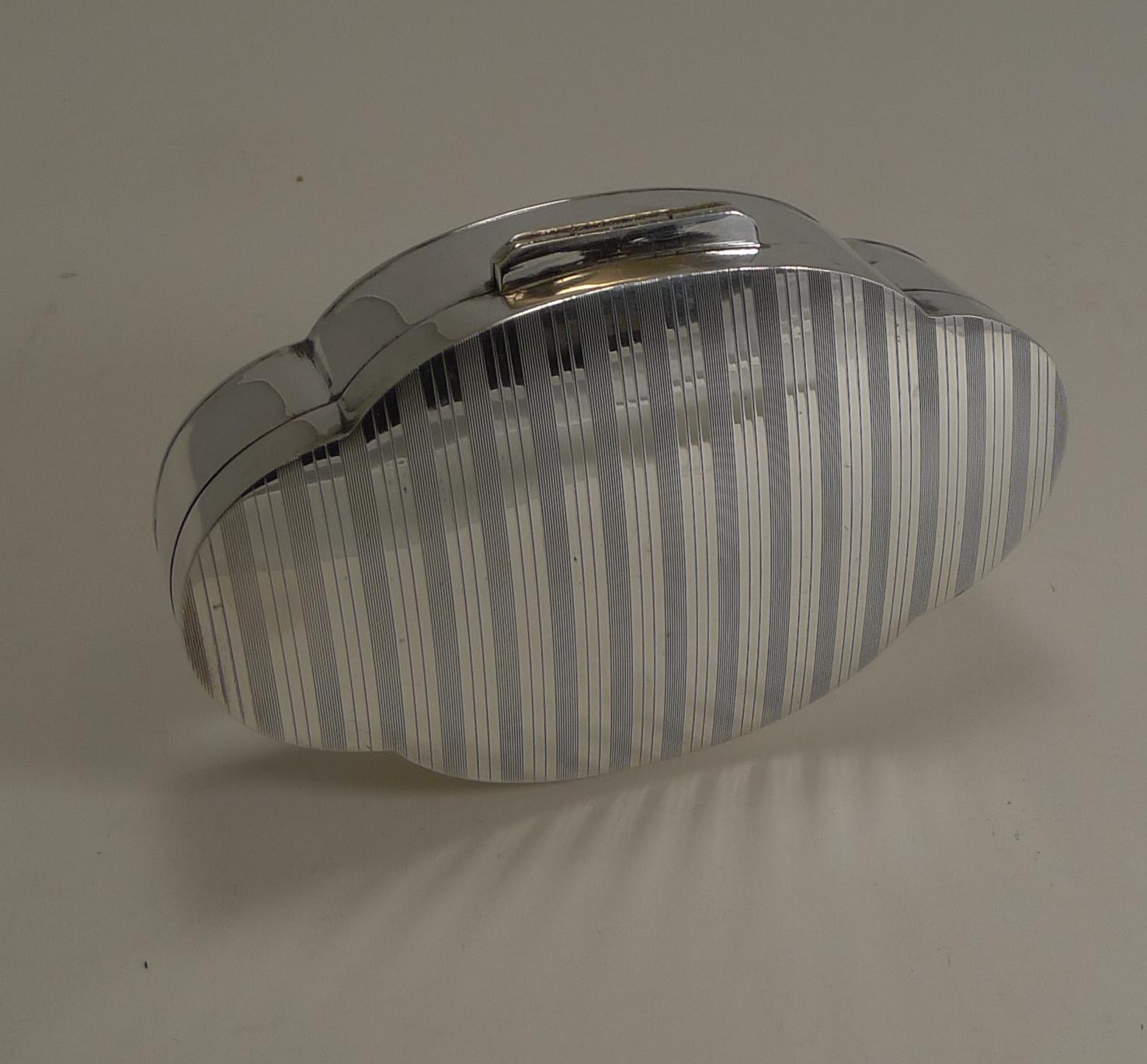 This is a really smart box, perfect for either a lady or gentleman. Made from solid English sterling silver the box has a good weight of 4.75 troy ounces / 147.8 grams.

The shaped box has a slightly domed lid with an all over striped engine