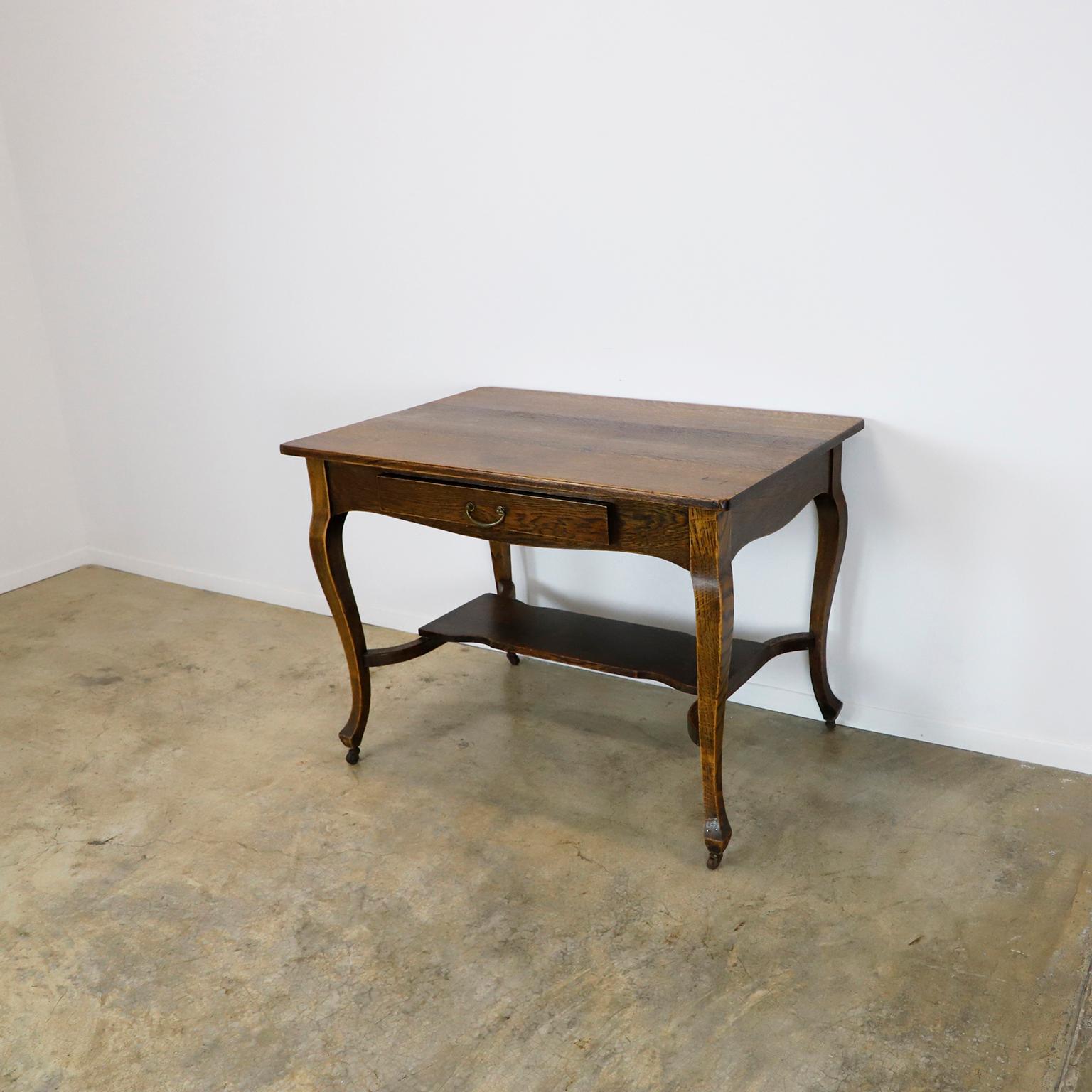 Circa 1920 we offer this Solid Antique Oak Writing Table.