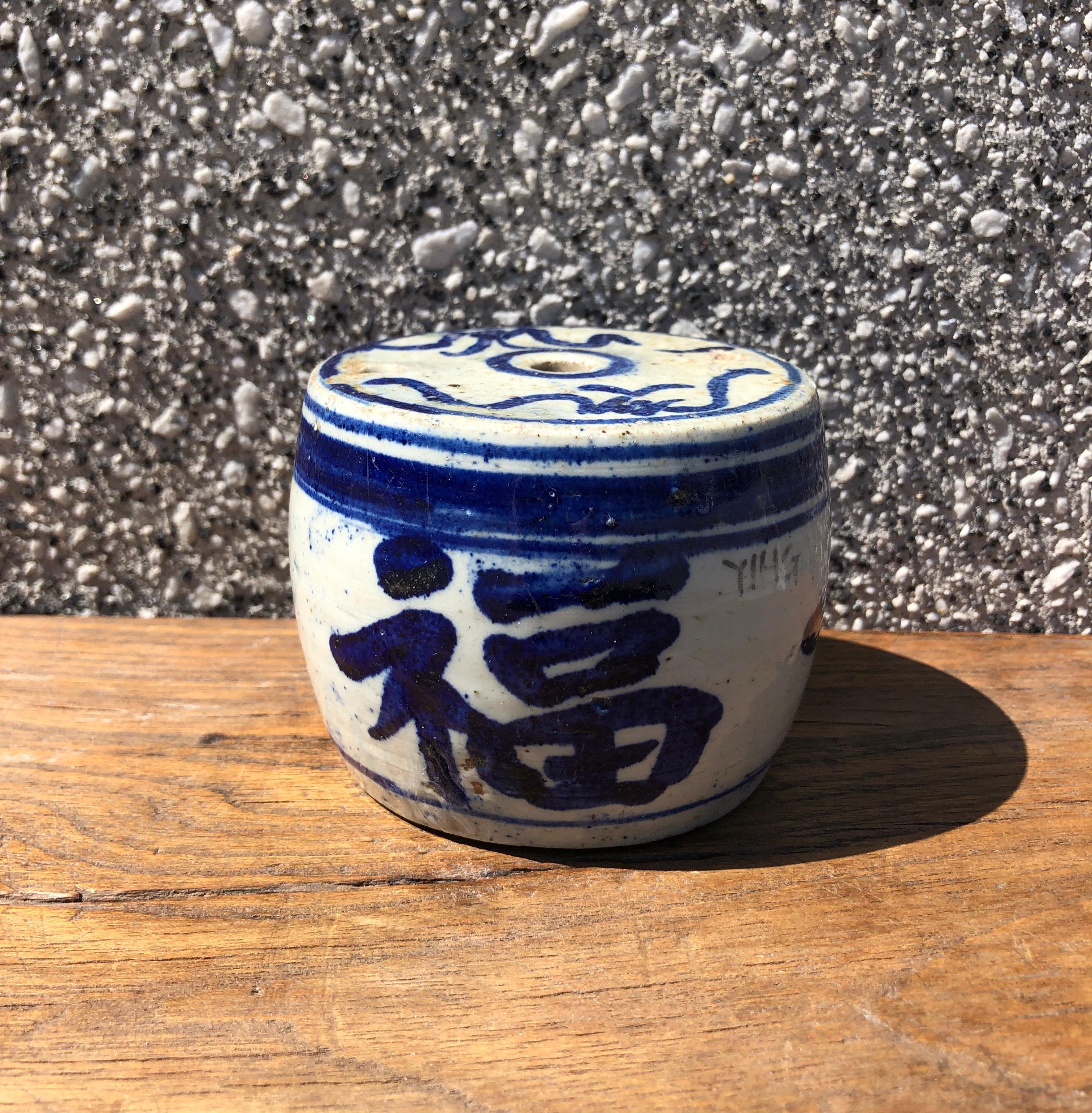 A heavy, drum shaped solid porcelain stick incense holder. Features striking bold dark blue hand painted calligraphy. Great desk accessory or shelf piece, China, c. 1880 or earlier.