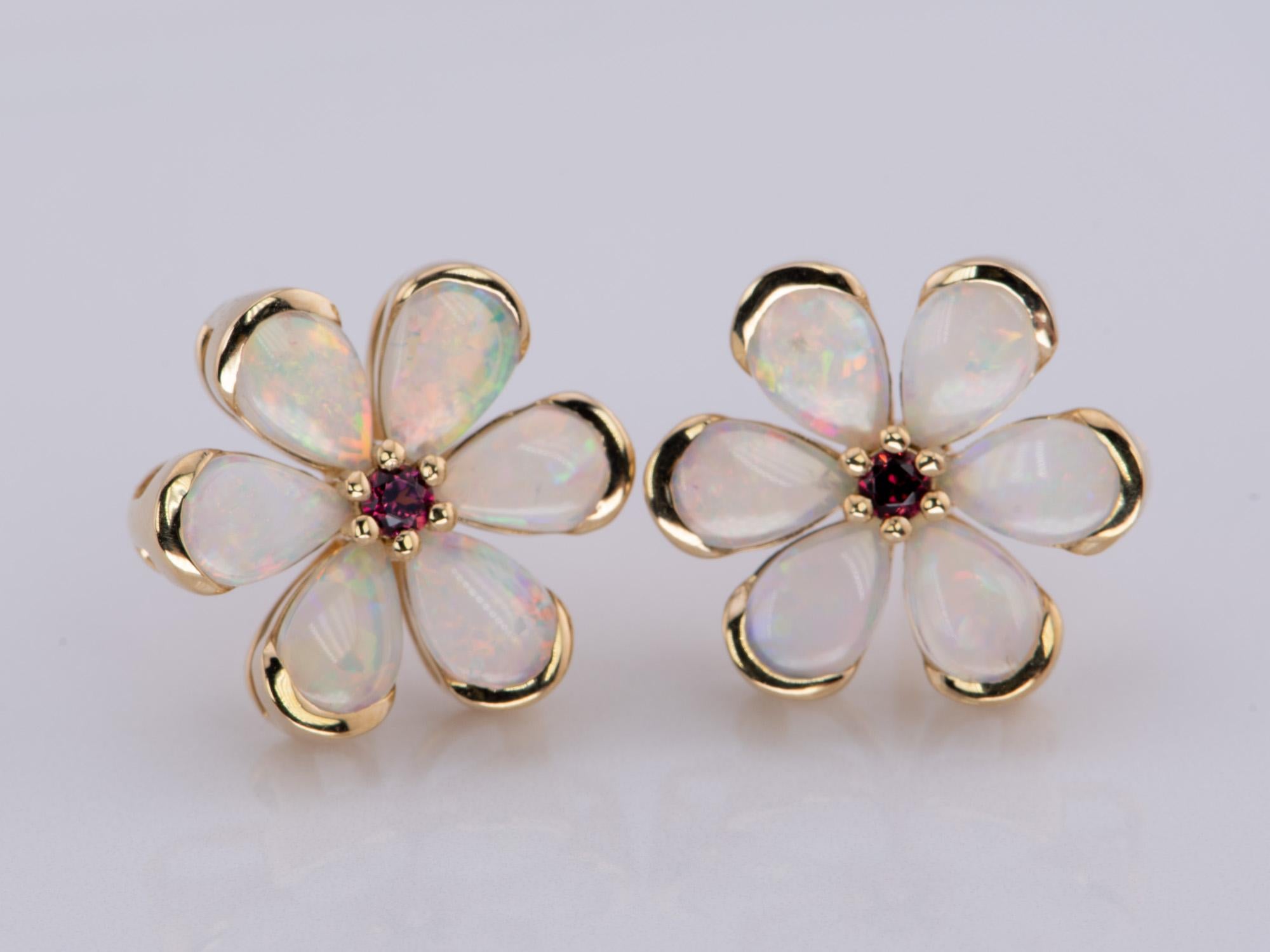 ♥ Solid Australian Opal Floral Style Earrings with Garnet Center 14K Gold
♥ The item measures 14mm in length, 15.2mm in width, and 4.7mm in height.
♥ Material: 14K Yellow Gold
♥ Gemstone: Opal, garnet
♥ All stone(s) used are genuine, earth-mined,