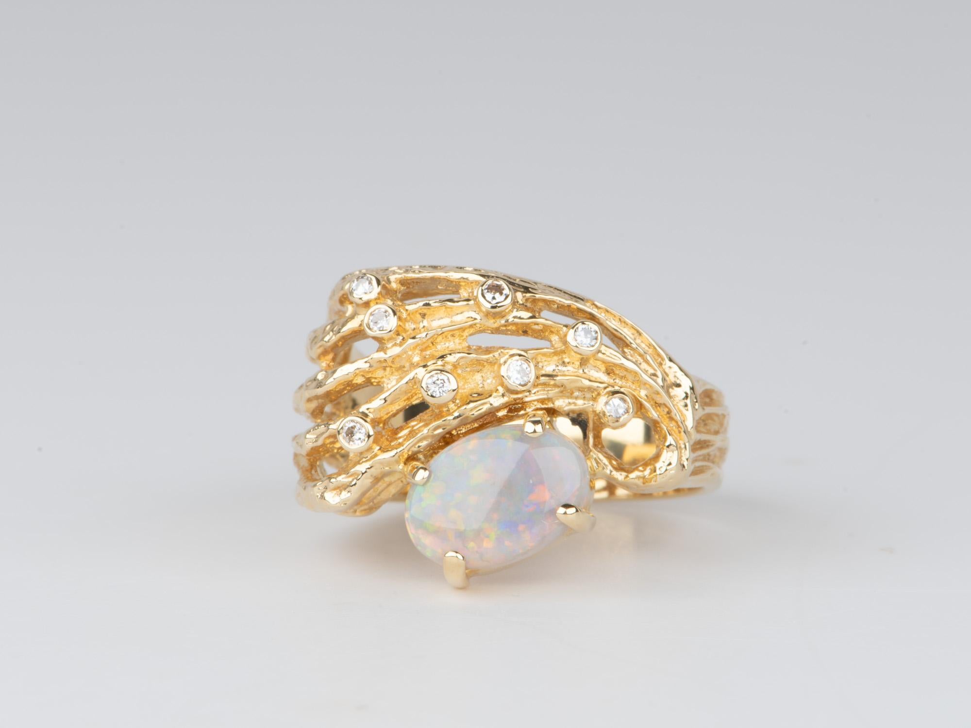 This captivating 18K gold chunky ring features a modernist design in a hand-carved organic style, set with a solid Australian opal and brilliant diamonds in bezel setting. Solidly made, this ring weighs 7.2g in gorgeous 18K gold and will feel