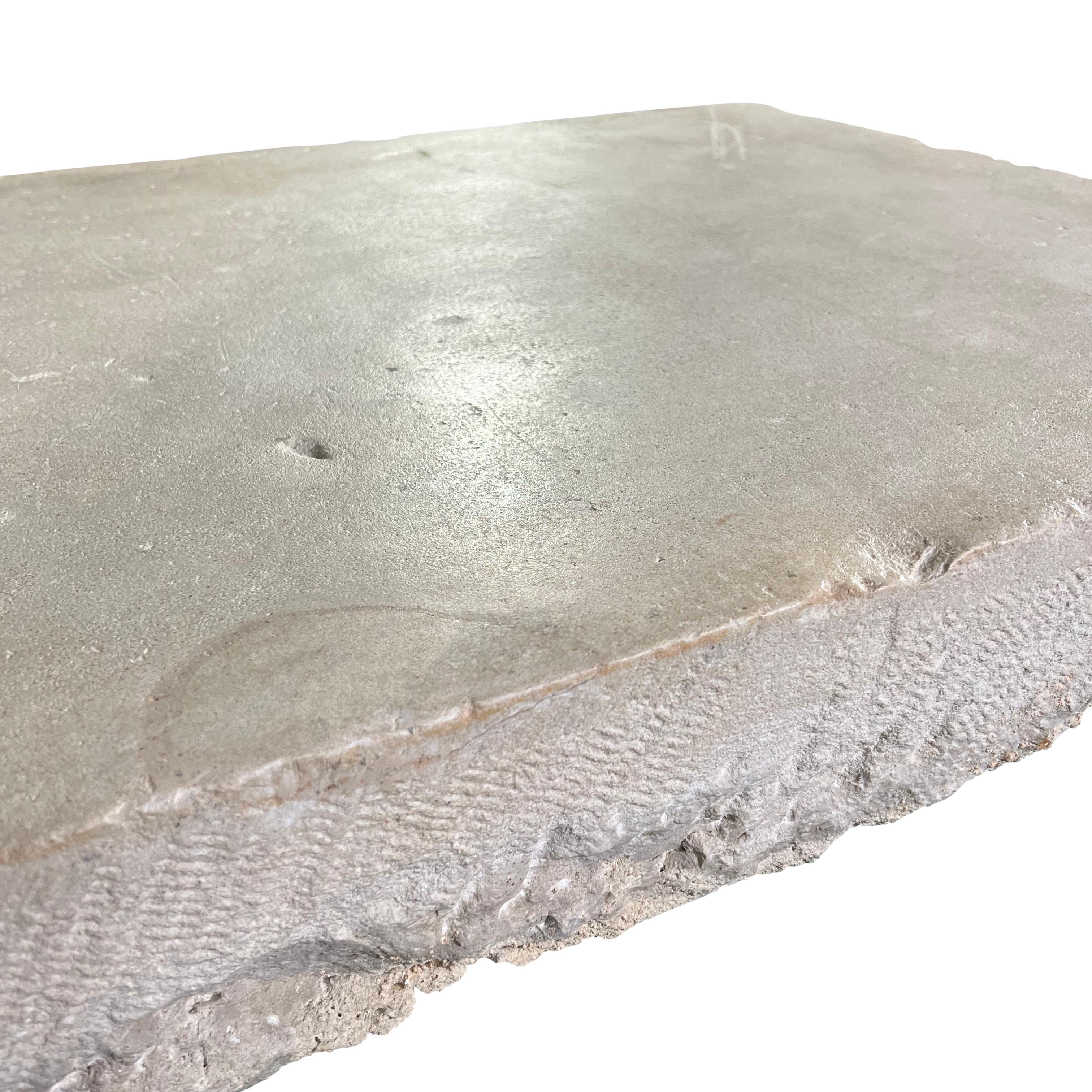 This solid base stone is a striking piece of off-white French limestone, perfect for those who appreciate the timeless elegance of Axel Vervoordt’s aesthetic. The rectangular, reclaimed limestone bears the mark of original artempo wear, giving it an