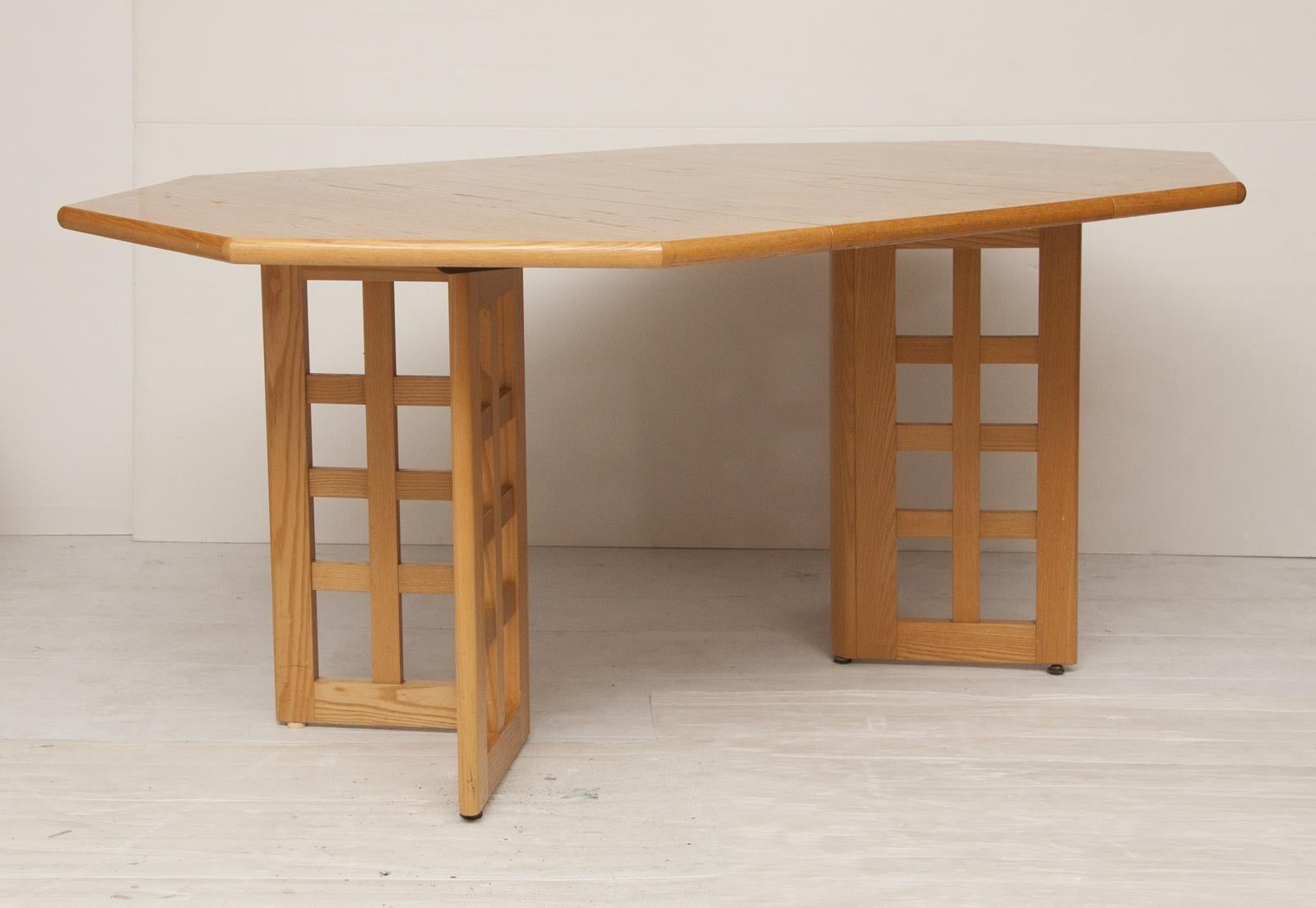 A vintage 1960s extendable dining table and chairs made in solid beech with square detailing throughout the chair backs and table legs.

Measures: Table - H: 75cm, W: 115cm, L: 115cm - 160cm

Chairs - H: 100cm, W: 47cm, D: 49cm.

 