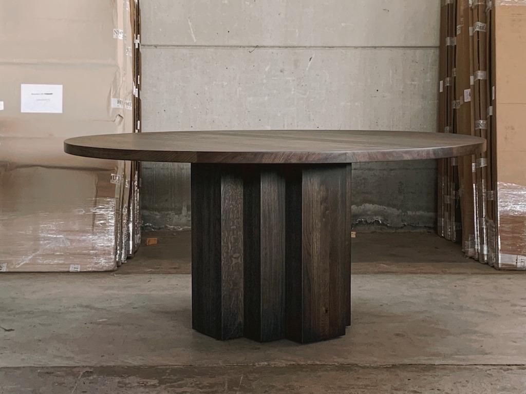 IN STOCK & READY TO SHIP.
Solid Oak Belgian dining table in Charcoal featuring a modern design, clean shape and a sculptural base. This strong table is handmade of long-lasting oak and finished with charcoal brown oil.  A table to grow old with and
