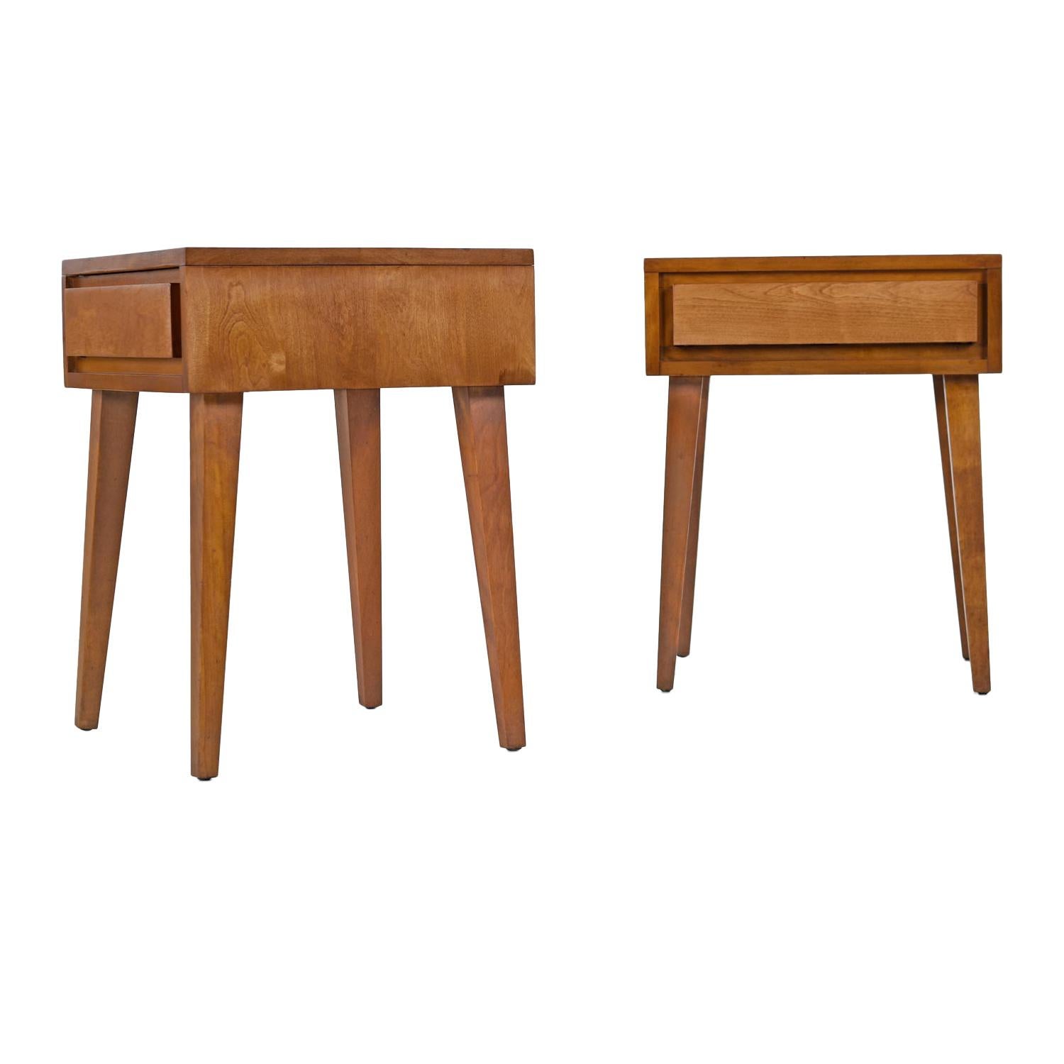 Pair of Mid-Century Modern nightstands / end tables designed by 20th century American furniture luminary Leslie Diamond. Constructed of solid birch wood with architectural clean lines. This is a handsome piece from Conant Ball’s Modernmates