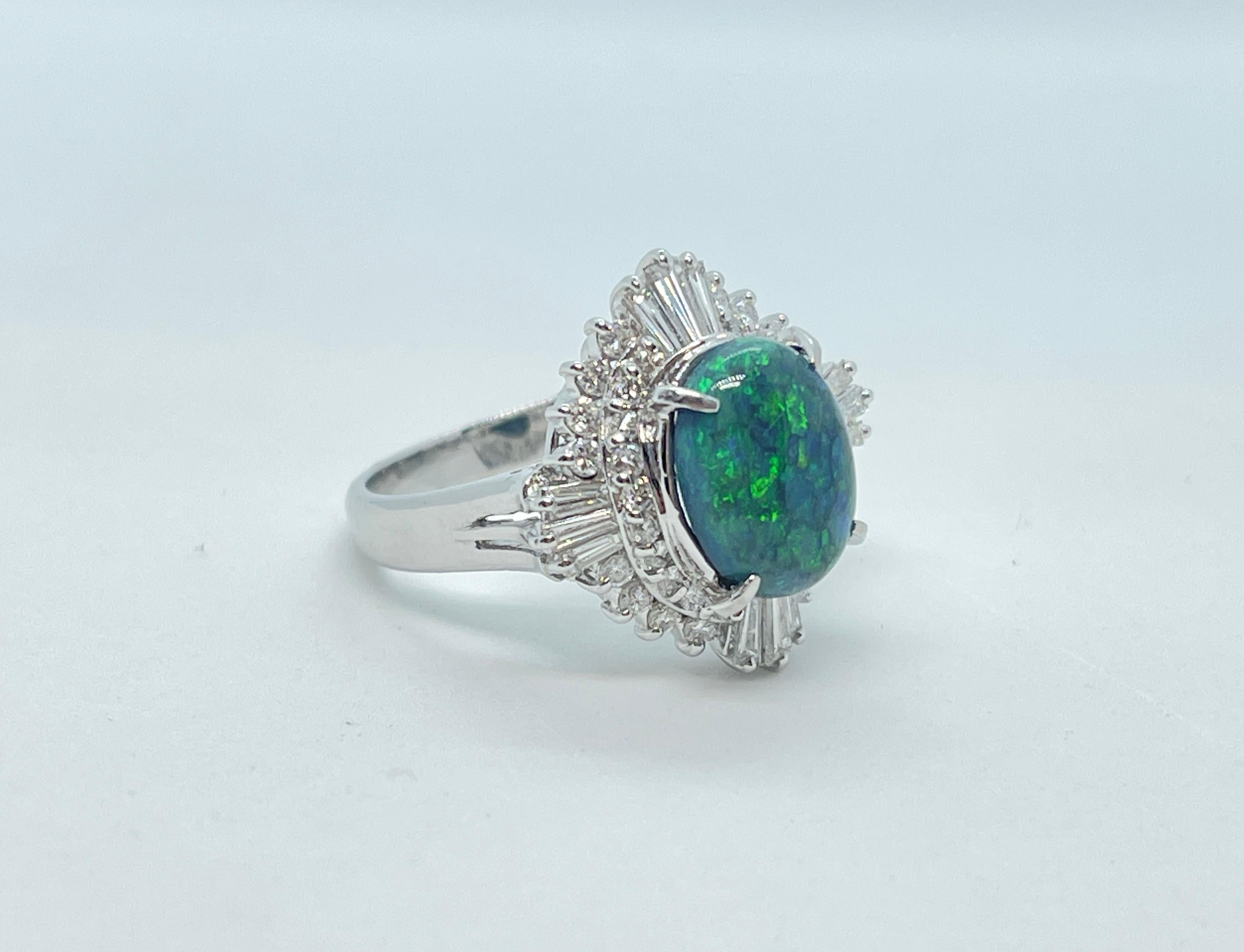This amazing ring features a 2.08ct solid Black Opal with blue/green play of colour. The Precious Opal was mined in Australia and is set in Platinum.  There are 36 x Diamonds surrounding the Opal in a Ballerina style setting which comprises of