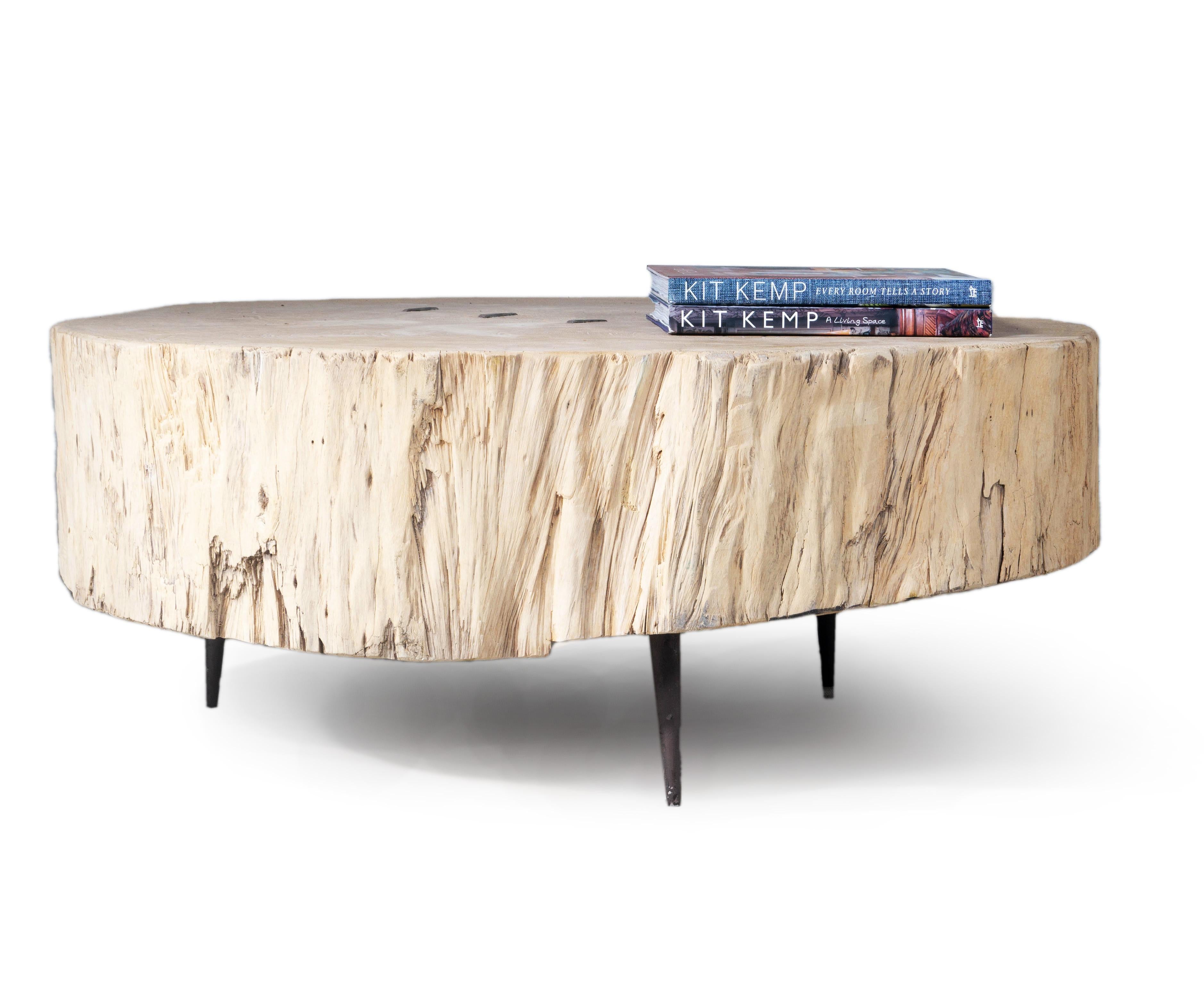 This elm stump coffee table will bring the natural beauty of wood into your home. Cleats have been wedged into the top of the elm for a handcrafted look, and simplistic metal legs have been added which add modern sophistication. The stump coffee