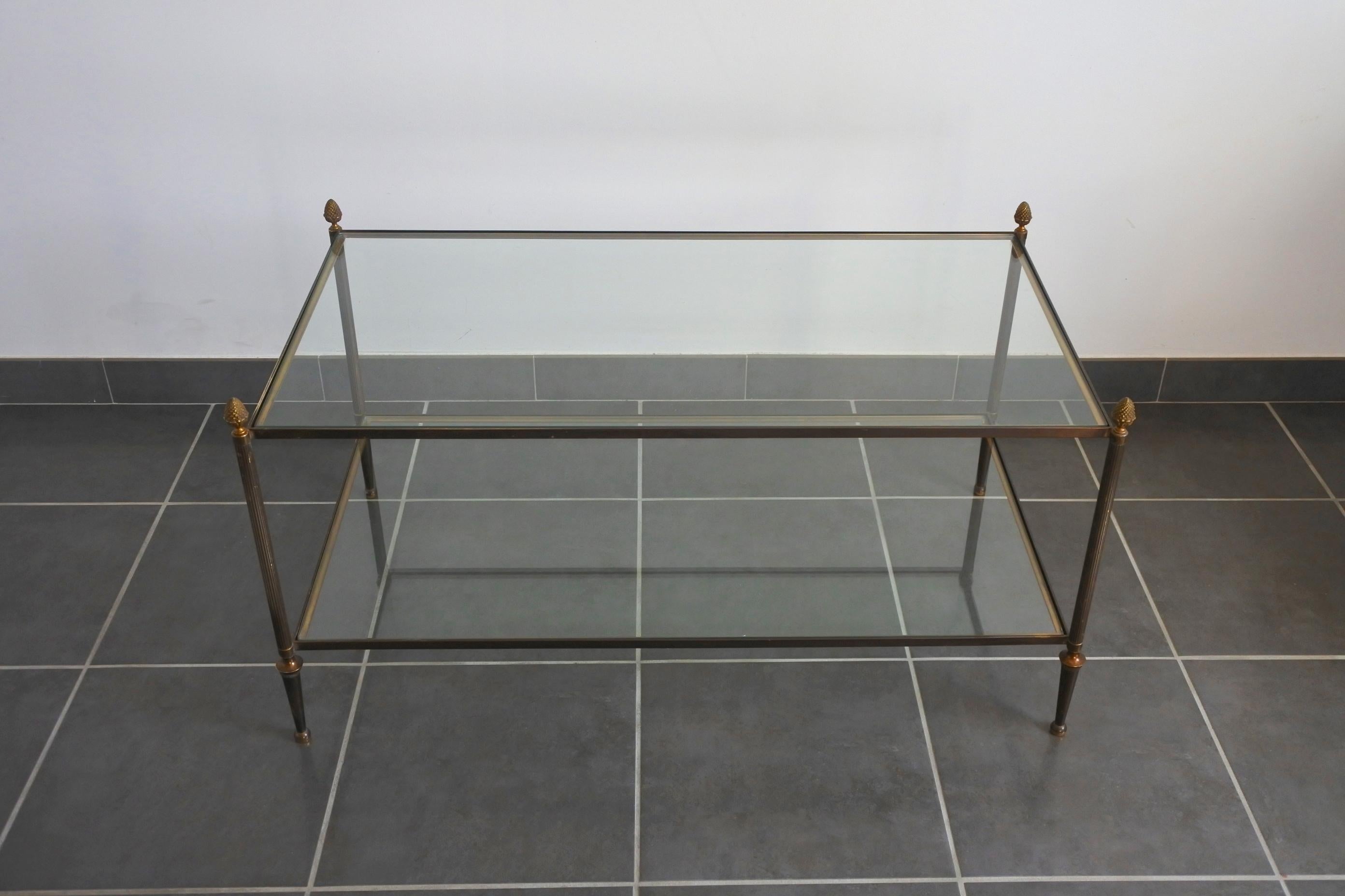 Neoclassical two-tiered coffee table
Solid brass and glass.
Made in France.
Original and beautifully aged patina to the brass.