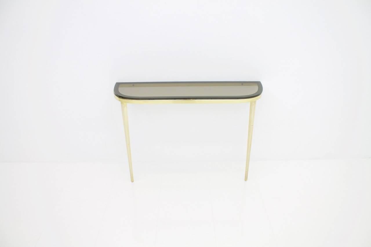 Wall-mounted console in solid brass and glass top, Germany, 1960s.
Measures: W 90 cm, H 60 cm, D 26 cm
Very good condition.

 
