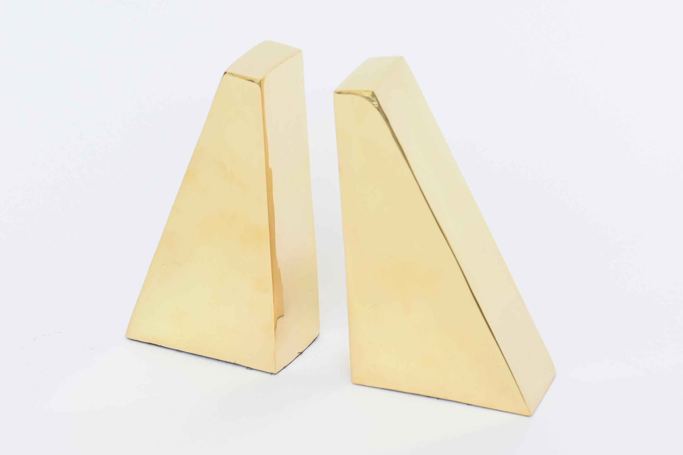 This polished pair of angled brass bookends are vintage. Mid-Century Modern. Great as a desk accessory or for a library or book shelf. They have great wright to them and have the original black velvet on the bottom.