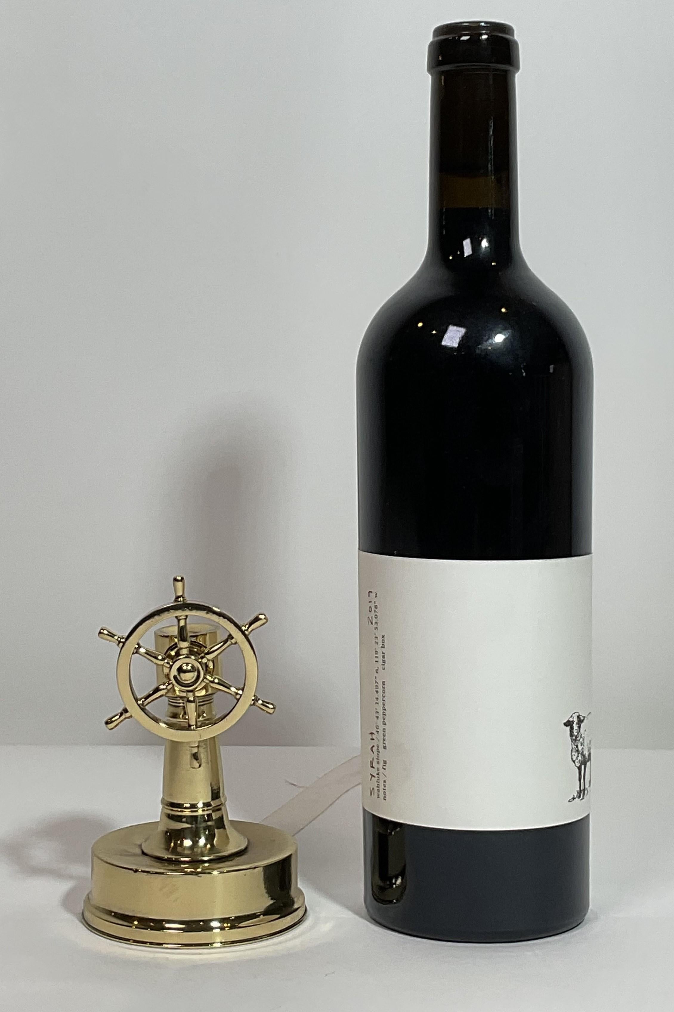 Nautical cigar cutter with a hole and cutting blade in the column. When the wheel is turned, the blade is engaged to cut the tip off the cigar. This cutter has been meticulously polished and lacquered. The column collects the tips, and the bottom of