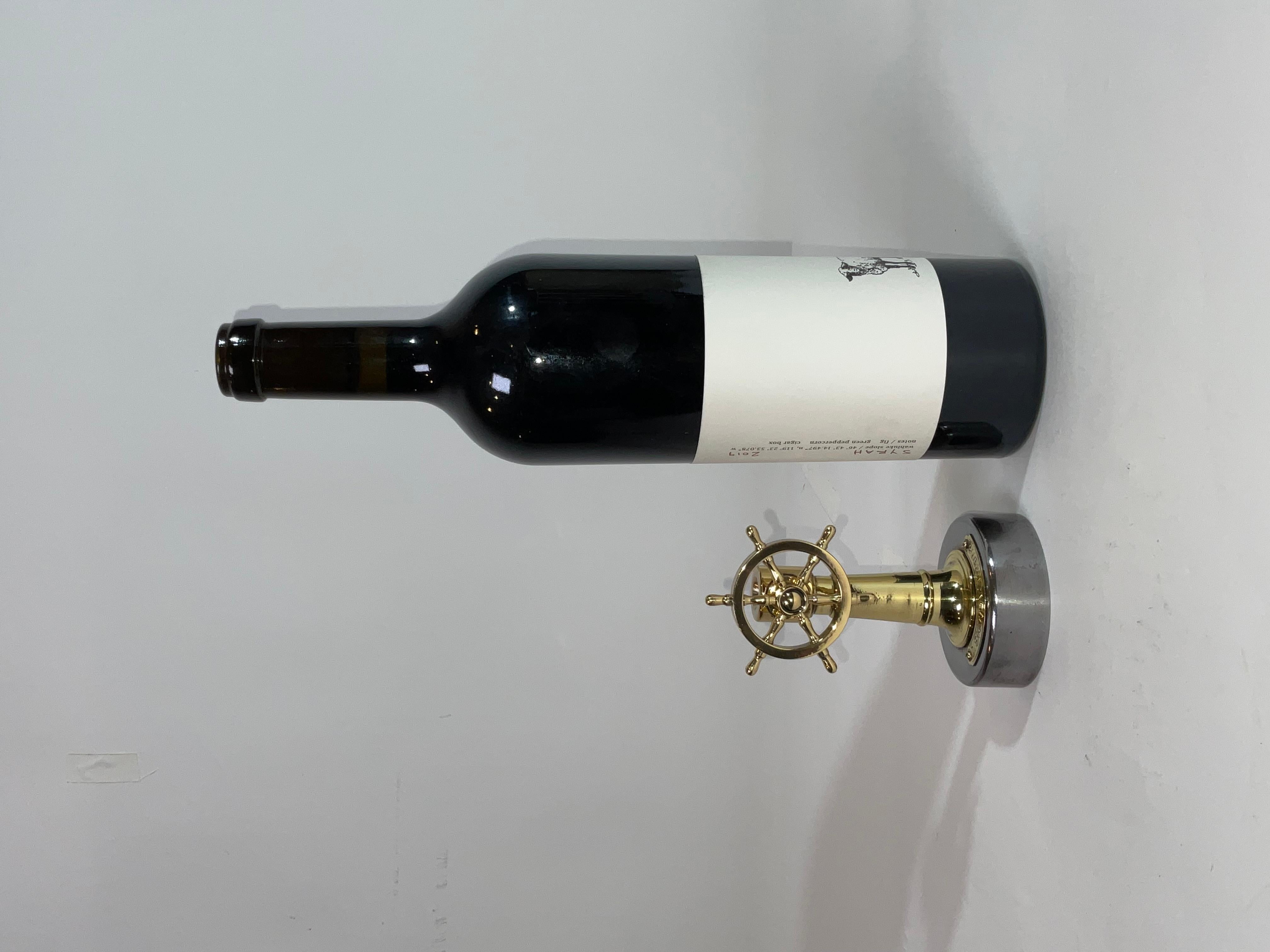 Nautical cigar cutter with a hole and cutting blade in the column. When the wheel is turned, the blade is engaged to cut the tip off the cigar. This cutter has been meticulously polished and lacquered. The base has a brass plate embossed 