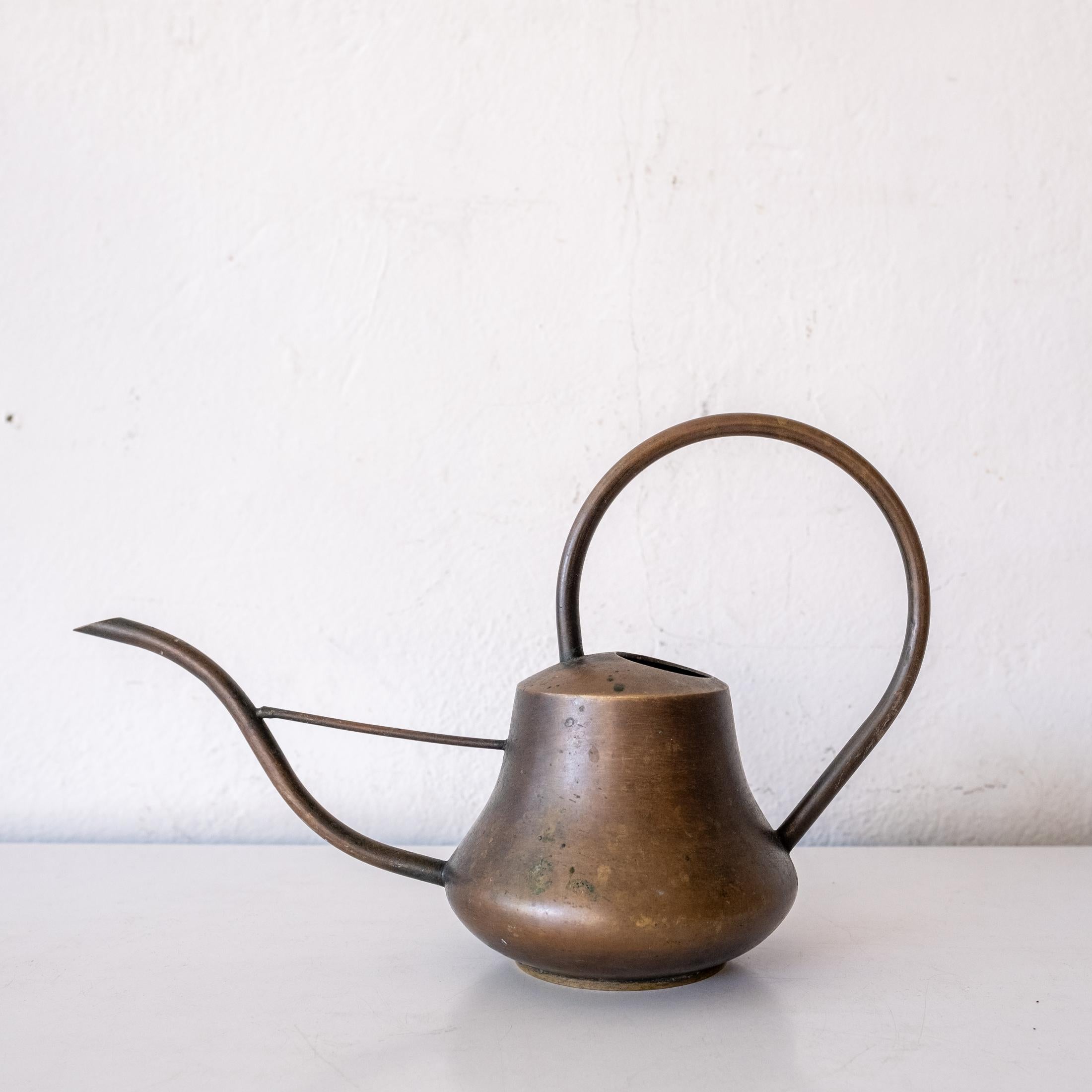 A high quality thick solid brass watering can. A functional Bauhaus aesthetic with a beautiful patina. Hand signed on the bottom. Watertight and pours nicely.
