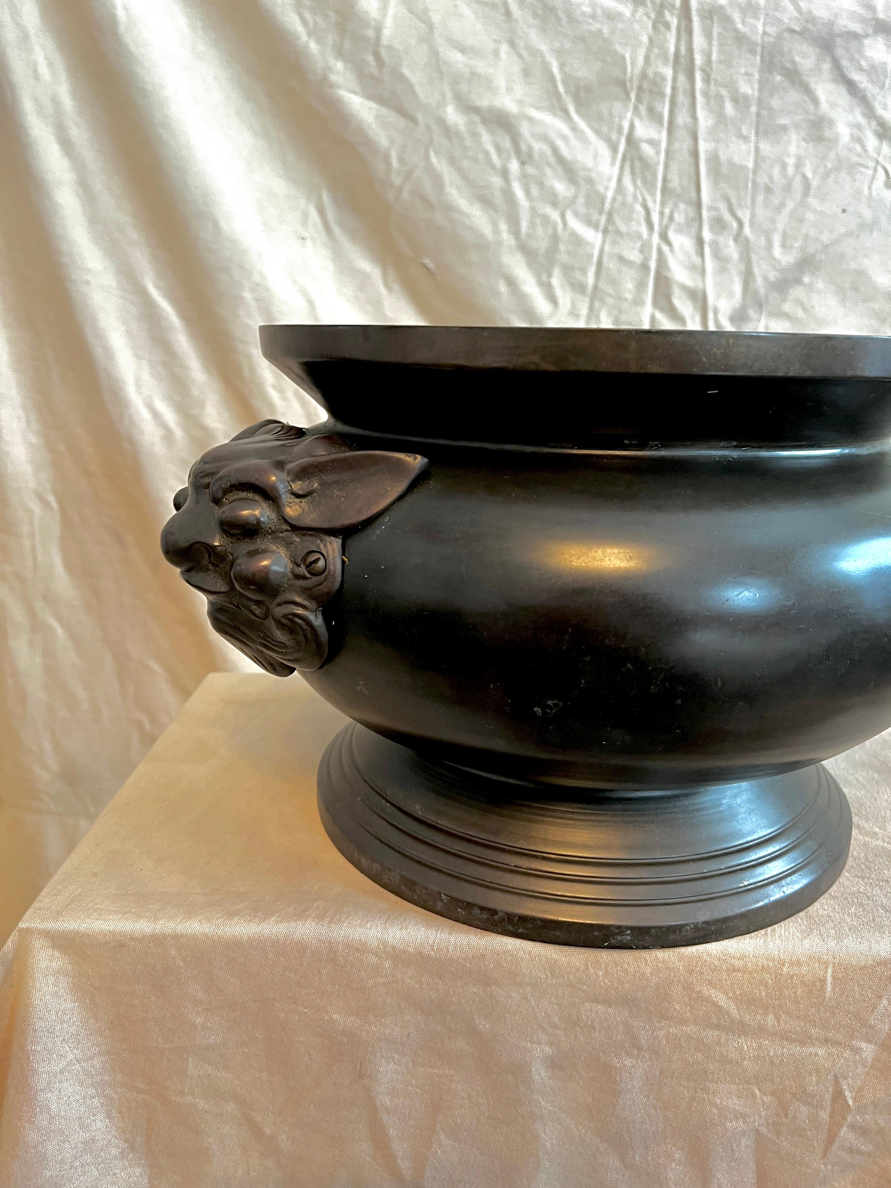 Beautifully Hand Crafted Bronze Cachepot or Jardiniere planter with Foo Dog Handles;.

The piece could easily be a center piece (see attache photos), a planter for house or garden plants and a Jardiniere, possibly housing a small citrus tree for
