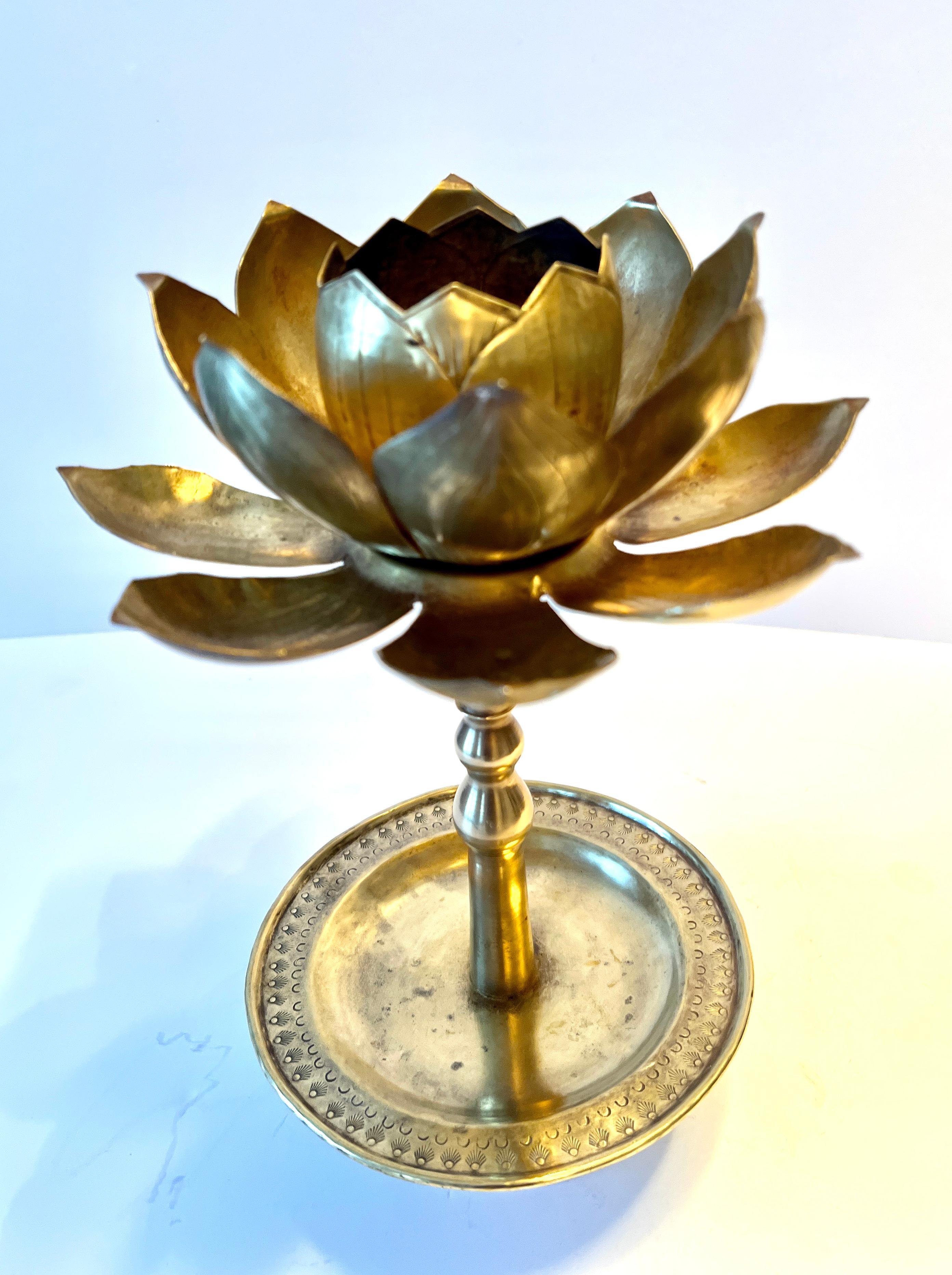 Iconic Lotus Shaped Candlestick by Chapman, the mid-century maker of wonderful lamps.  

The piece is a blooming lotus with a candle in the middle, on a tall center with a wound tray and footed bottom.  This classic piece is timeless and a