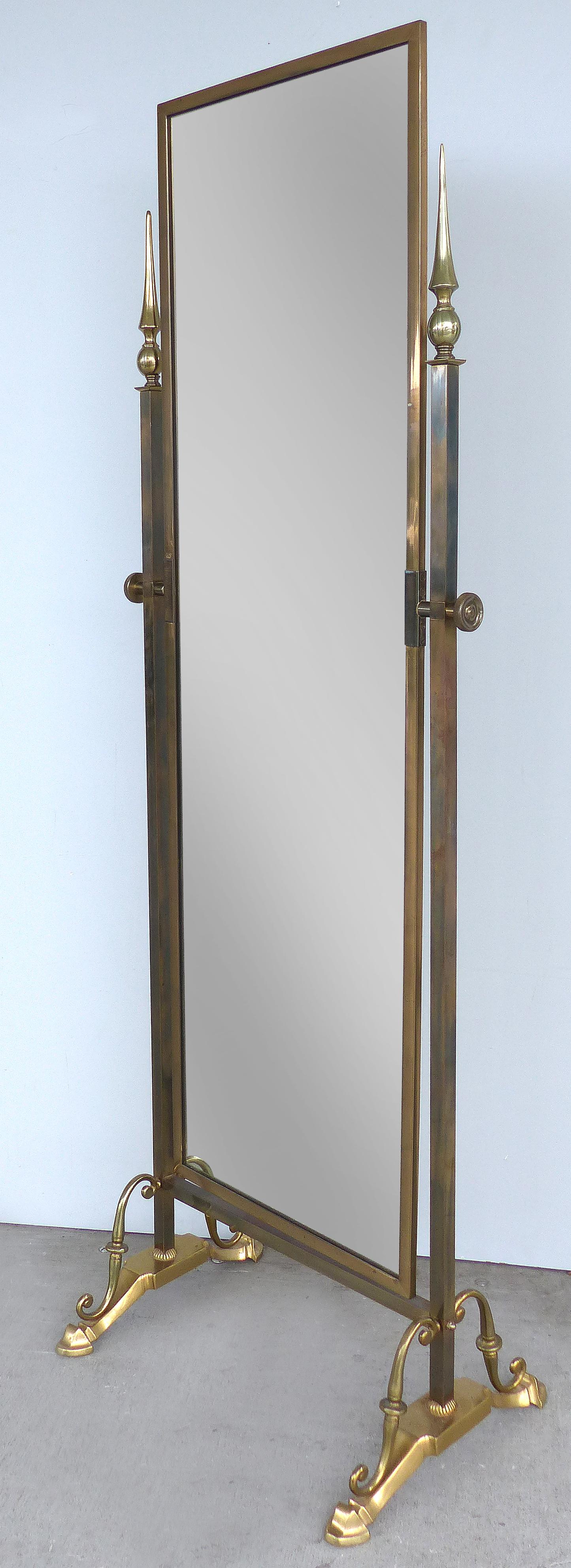 Offered for sale is an elegant solid brass cheval dressing mirror manufactured by Glo-Mar Artworks Inc. of New York. The mirror is in excellent condition and rotates as desired. The back is clad in ribbed brass.