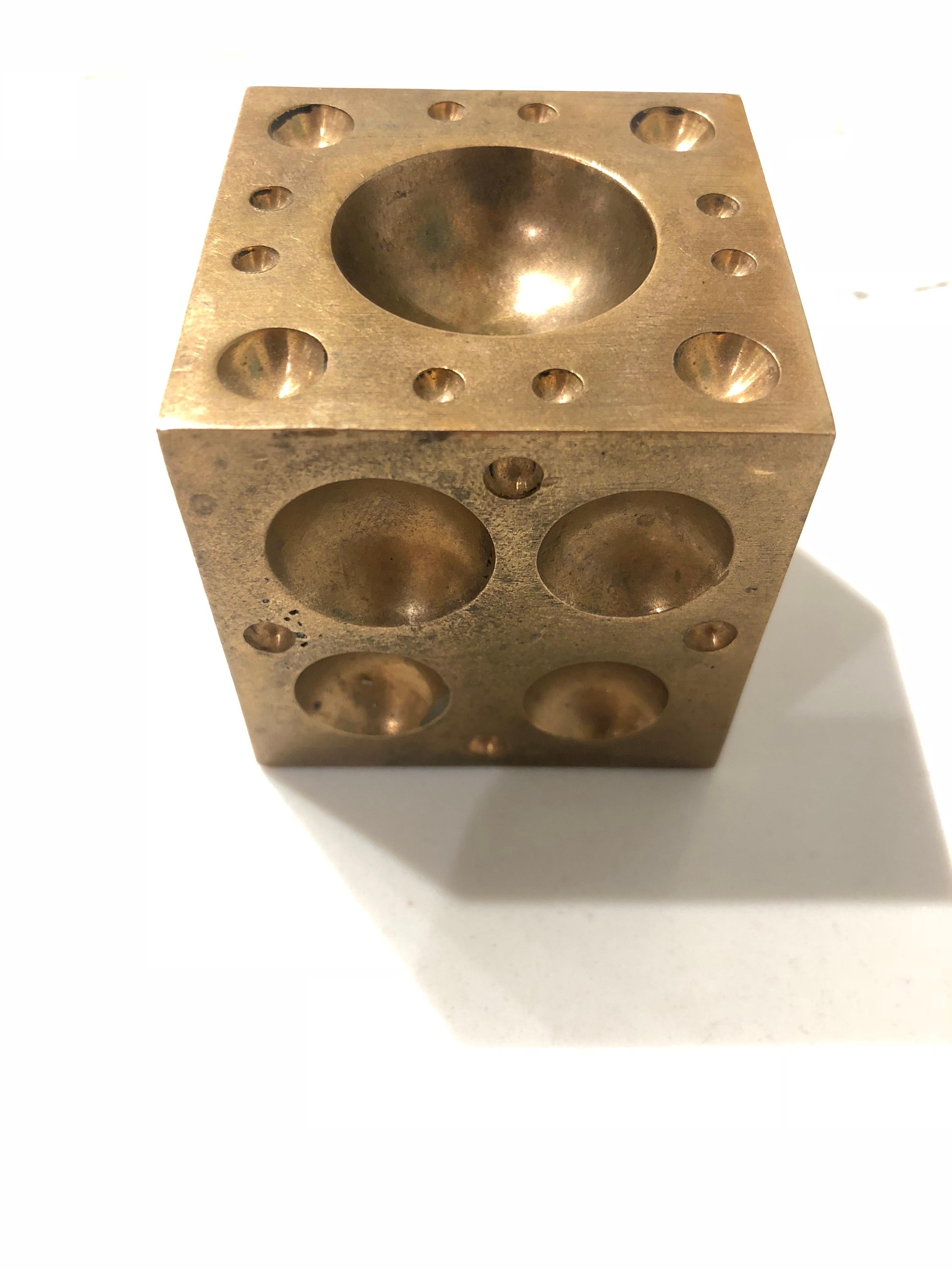 Nice and heavy unique paper weight sculpture, in solid brass each side comes with different sizes holes, circa 1970s.