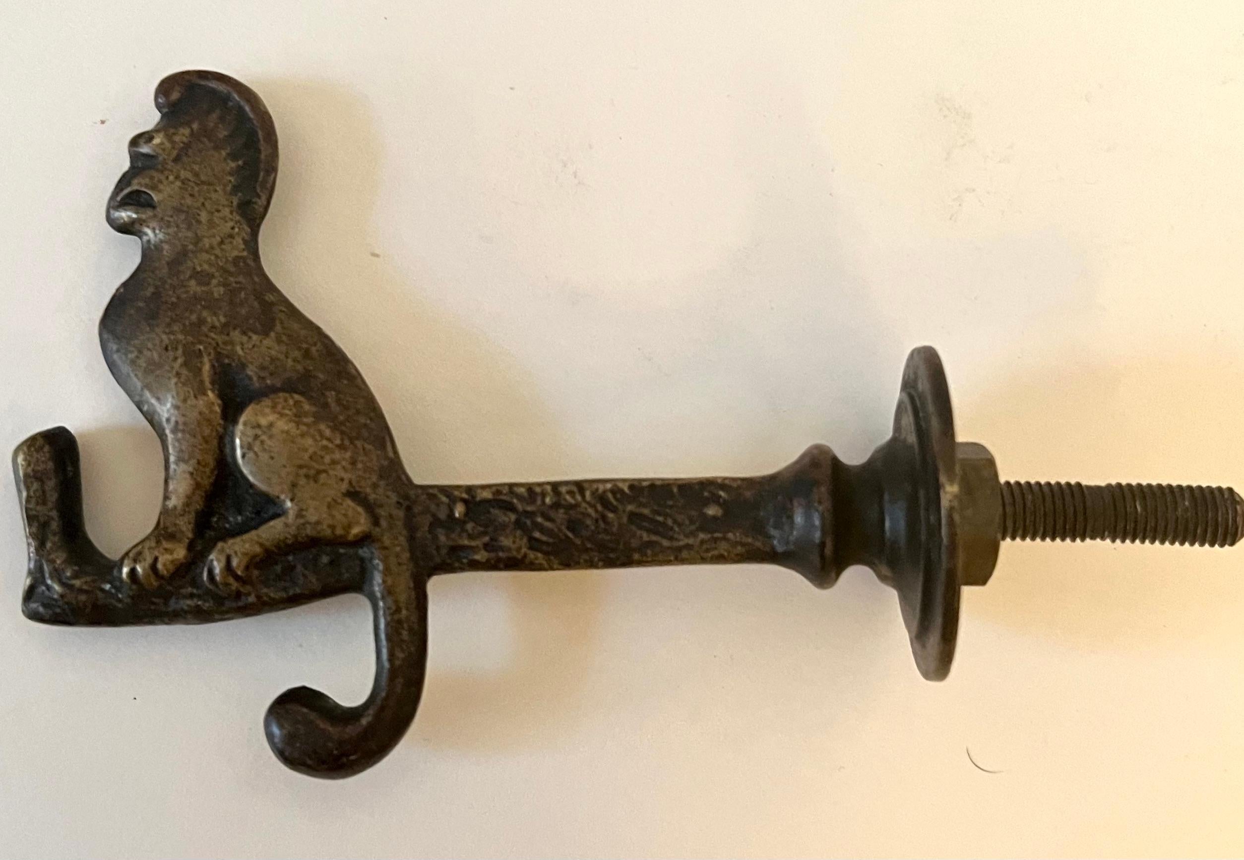 A solid brass door hook with a monkey on the end.  

A whimsical expression for many spaces - great for the back of a door, in a kitchen to hold bags or in a Childs room.

Very cute and functional as well.