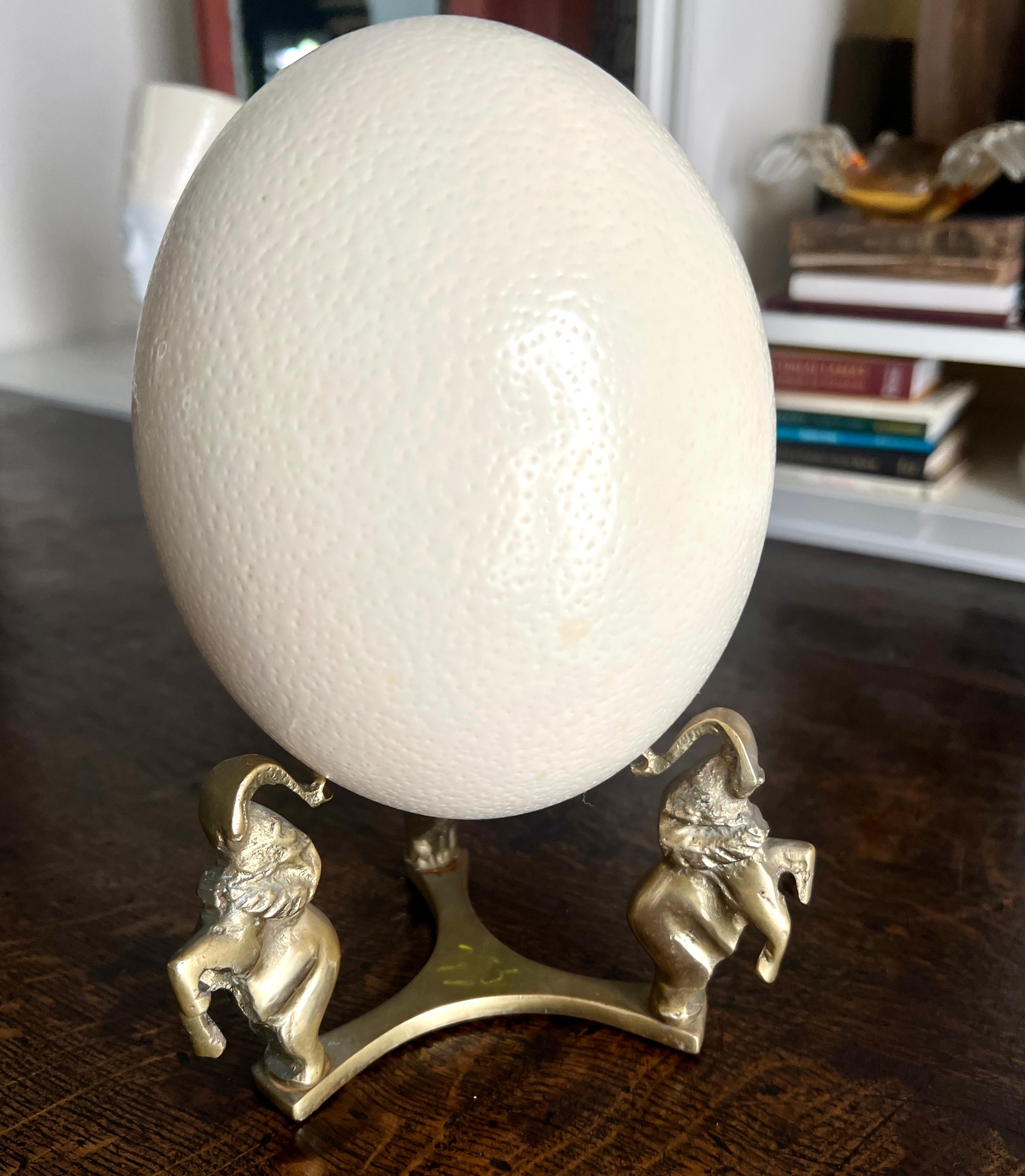 Patinated Solid Brass Elephant stand with Ostrich Egg For Sale