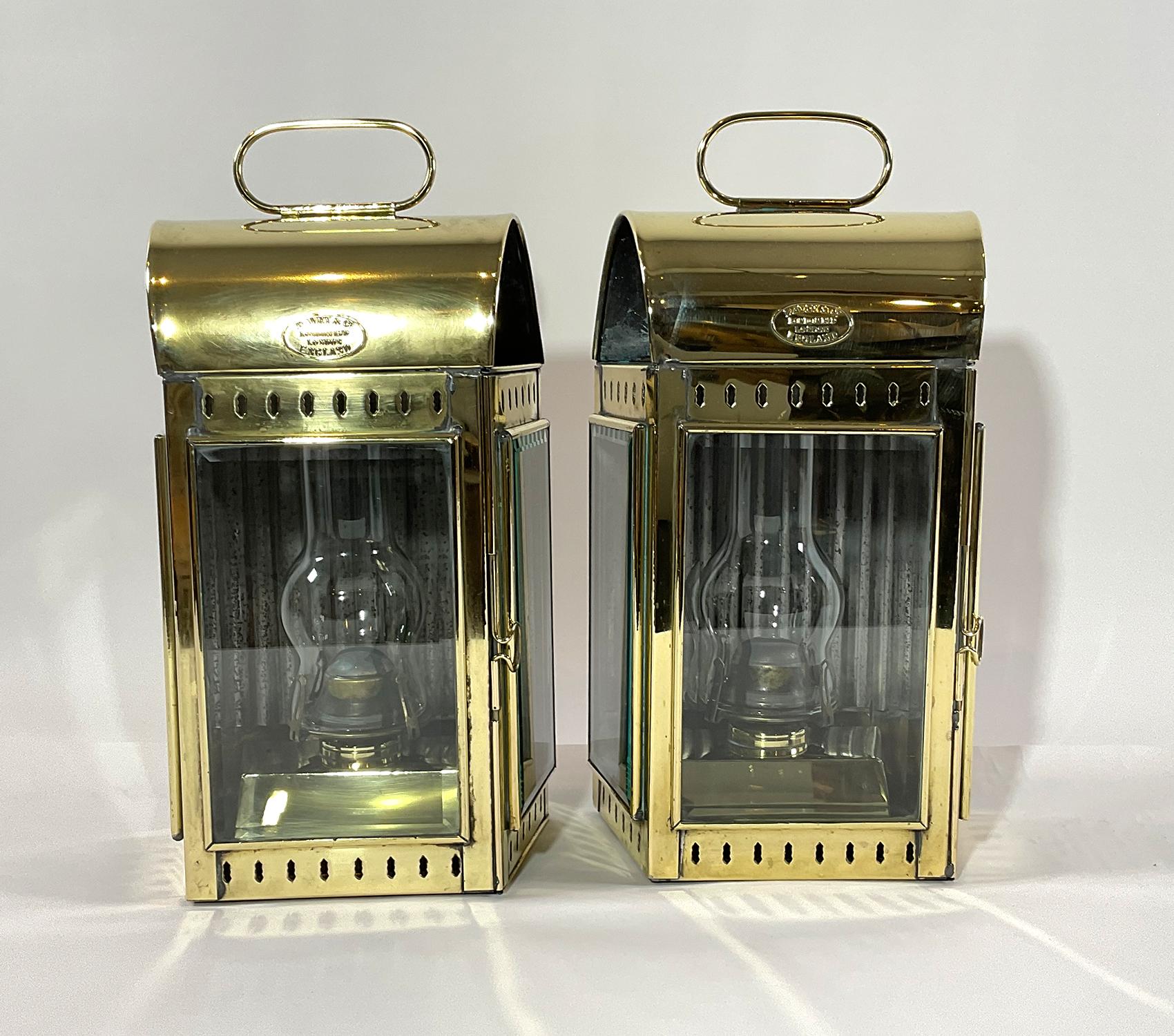 Pair of top quality solid brass ships lanterns with oval makers badges from Davey and Company of London, England. This pair has original burners, oil tanks, chimneys, beveled glasses, hinged doors and carry handles. Circa 1930.
