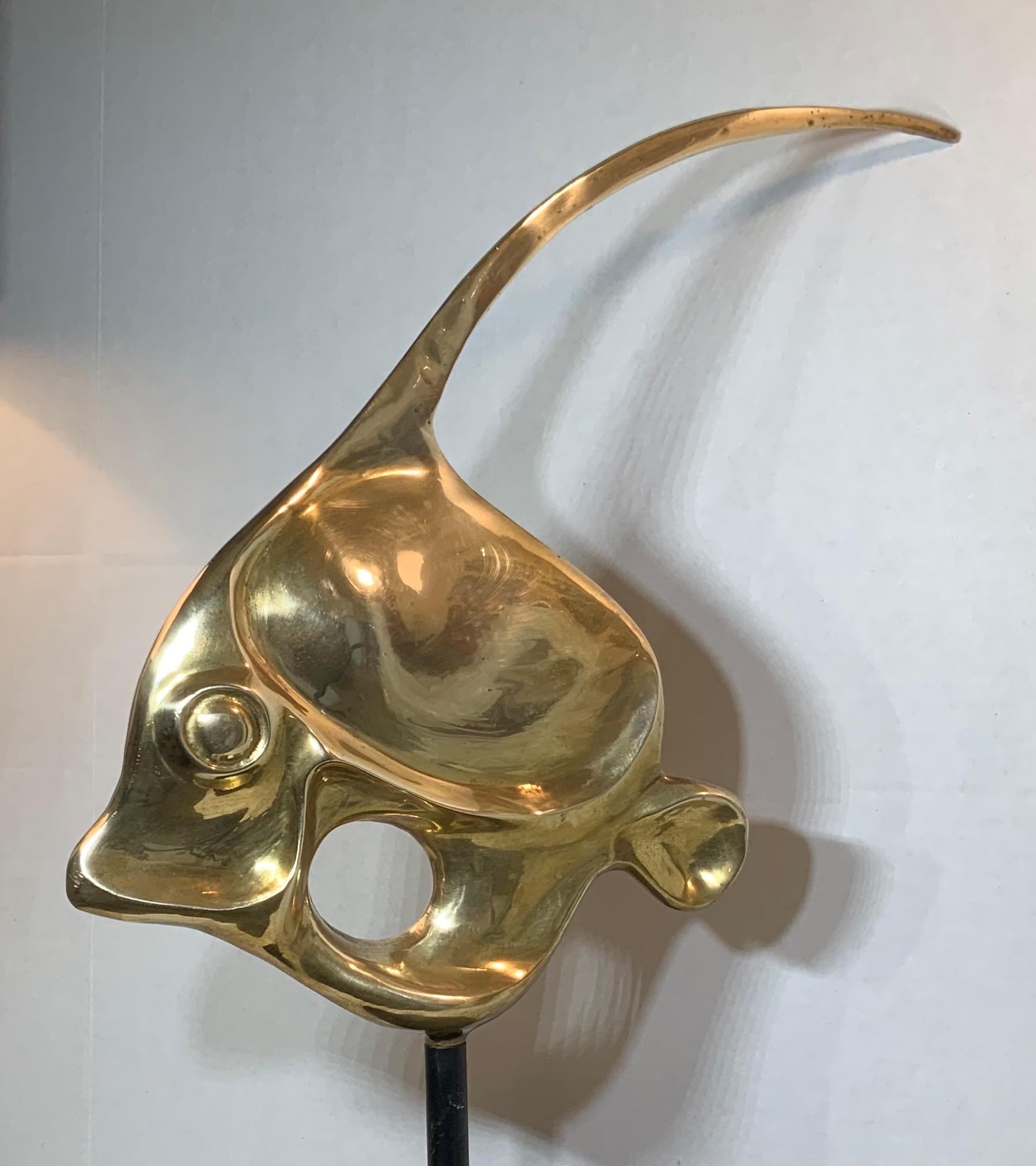 Elegant sculpture of fish made of solid brass, professionally mounted on custom made wood base. Beautiful decorative object of art.