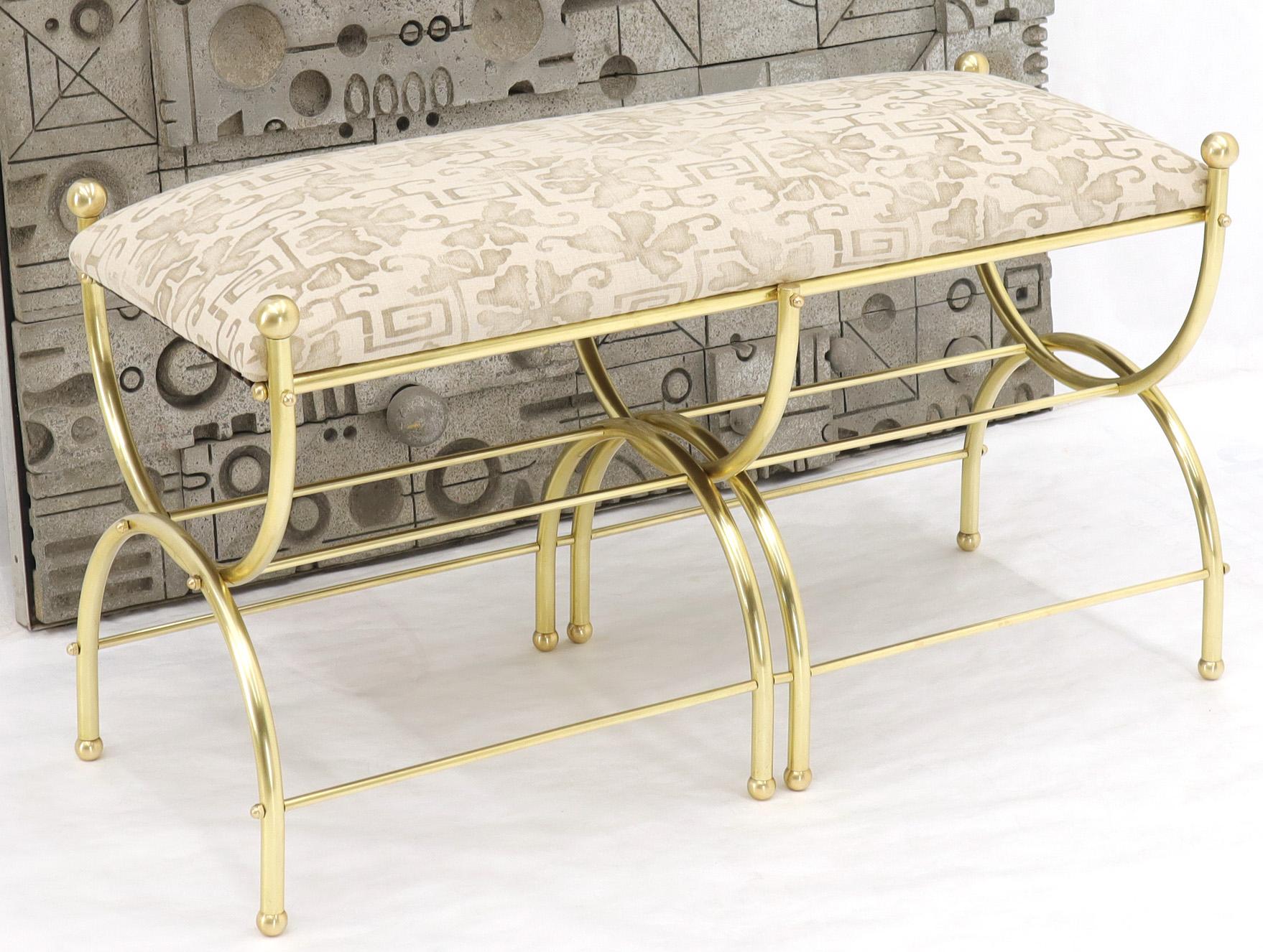 Mid-Century Modern heavy gage solid brass frame window bench. Heavy and solid brass machined finials. New upholstery. The frame has been completely repolished and refinished. Influence of Maison Jansen and Jean Royere.