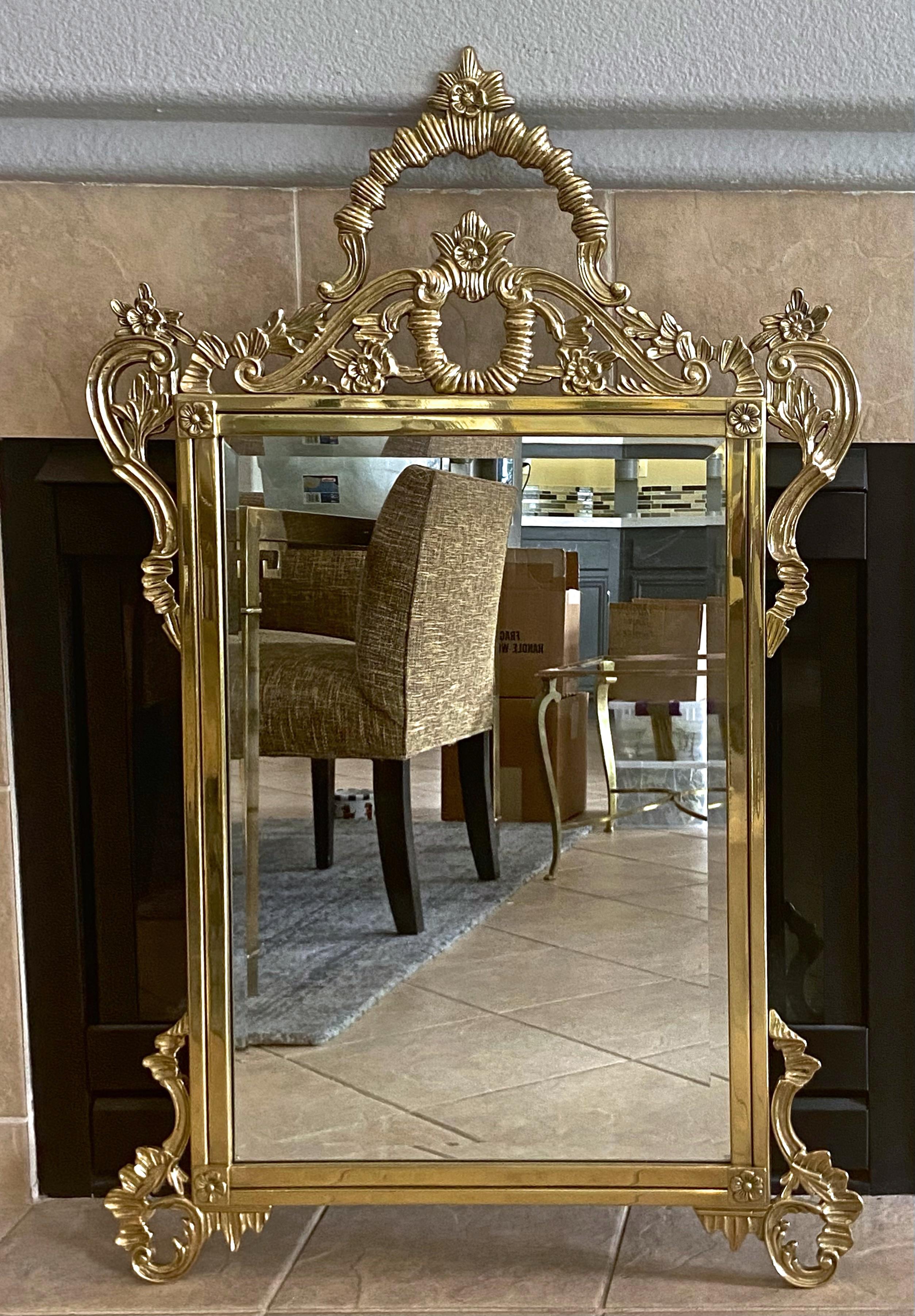 Solid brass French Rococo style beveled wall mirror. The brass is expertly casted retaining its original lacquered finish, in great condition free of oxidation or tarnish. Made in Europe possibly France late 40's.