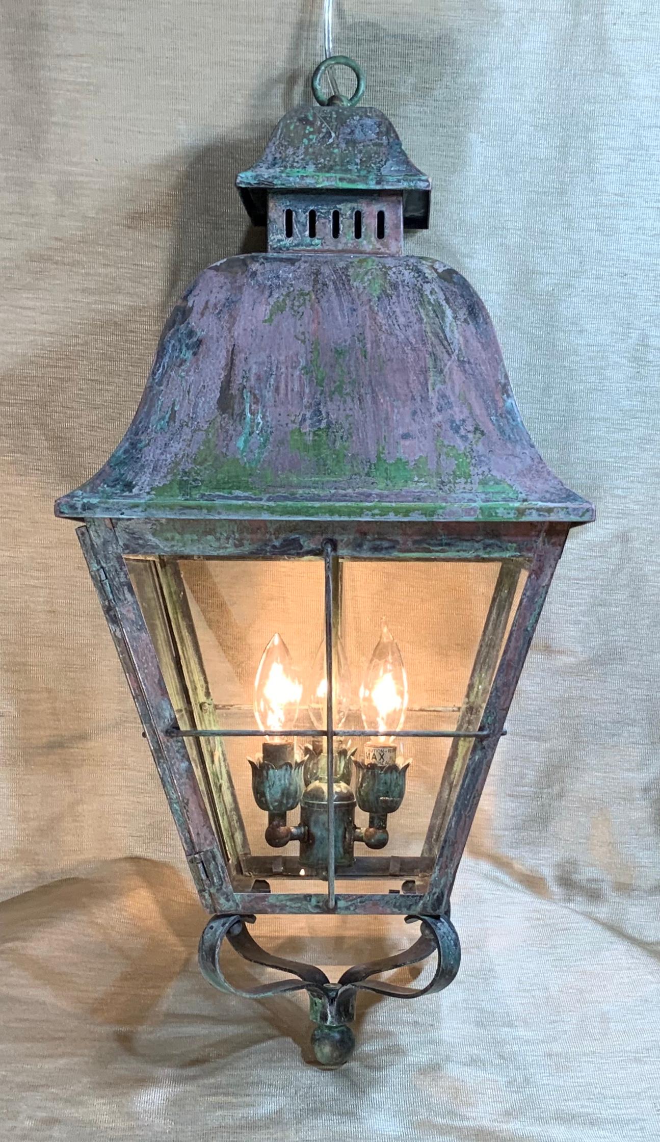Elegant hanging lantern made of solid brass with three 60/watt lights, suitable for wet locations ready to use. Brass canopy and chain included.