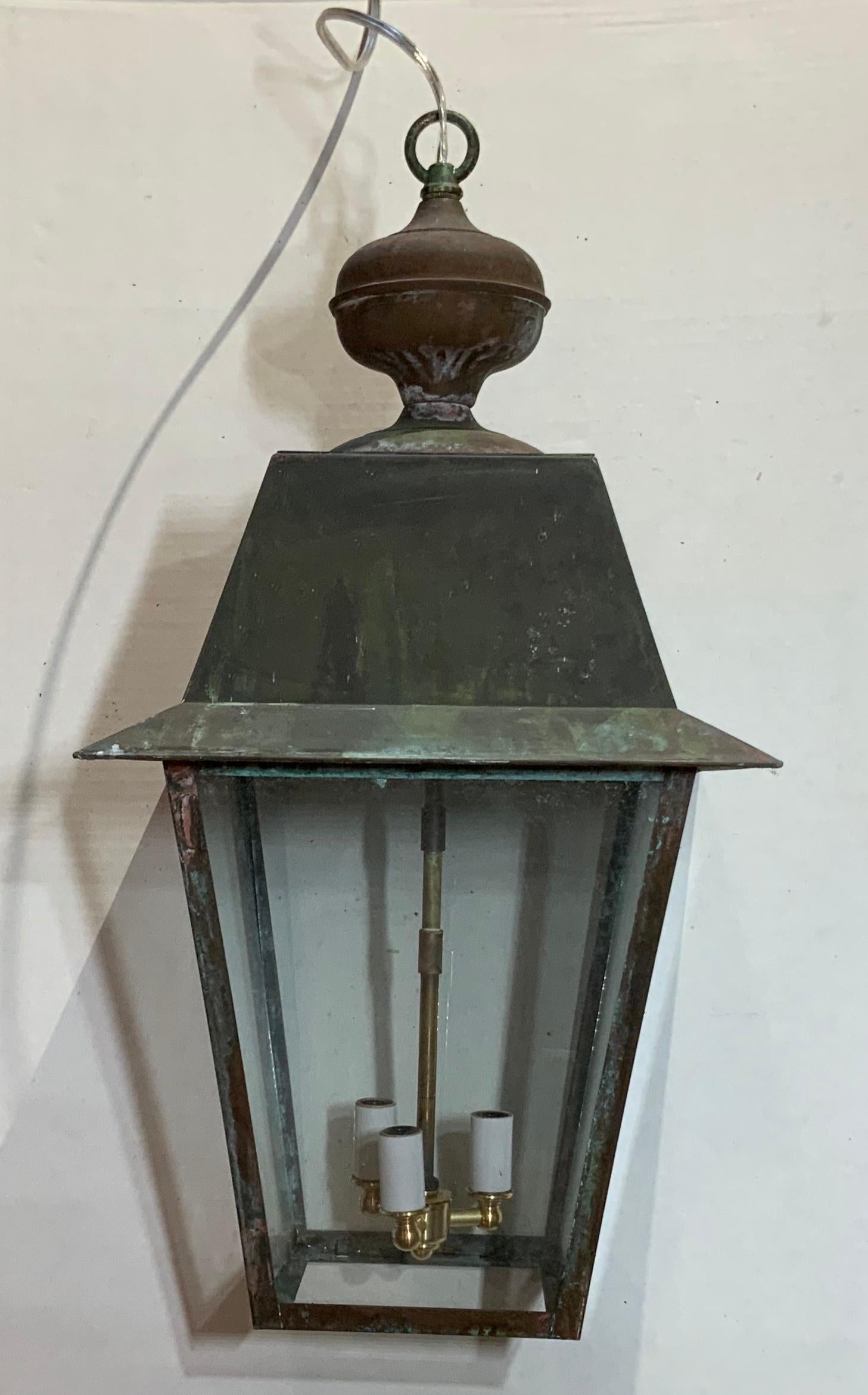 Four sides hanging Lantern made of solid brass with three 60/watt lights, newly rewired.
Brass canopy included.