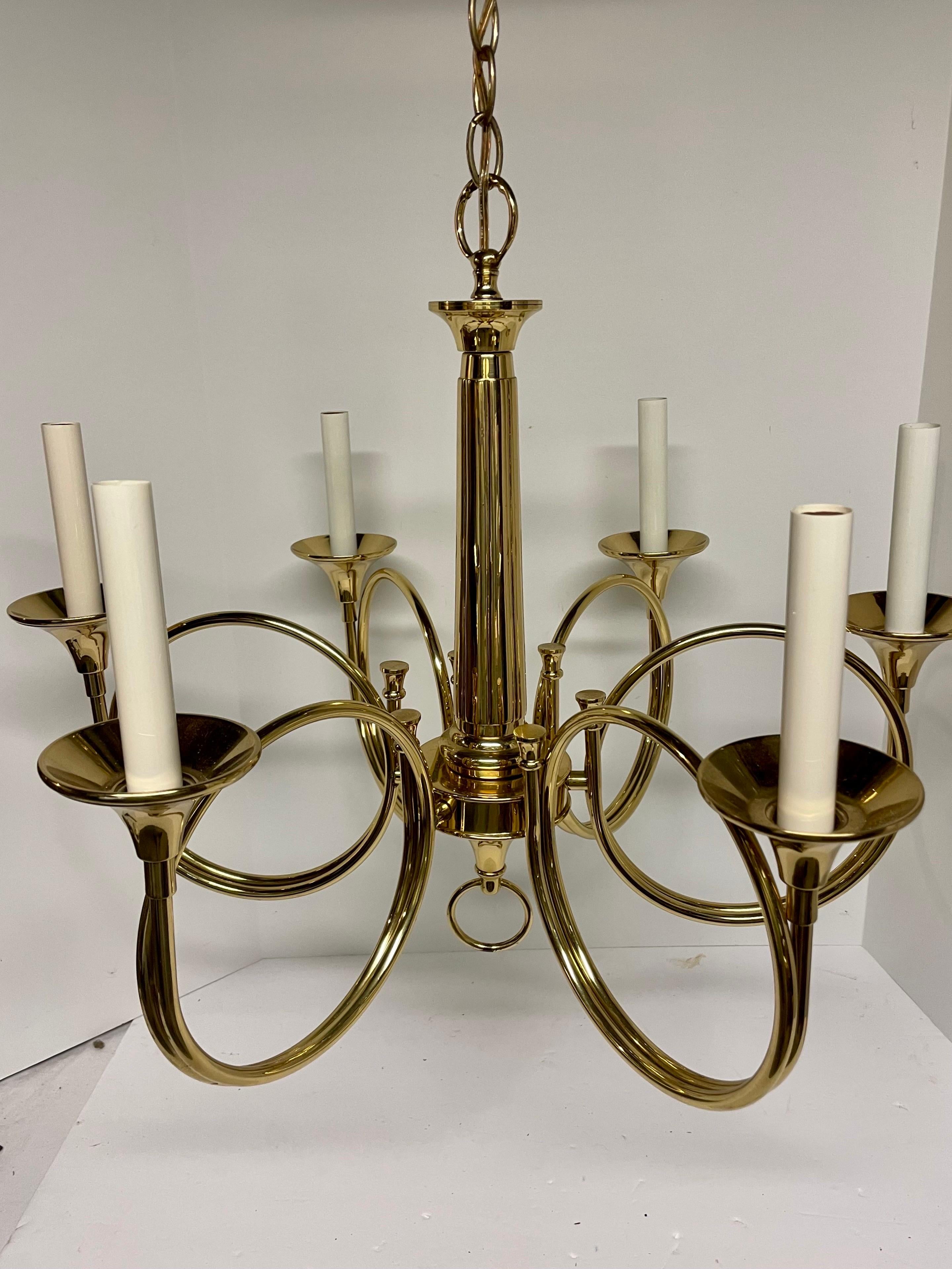 Solid Brass Hollywood Regency hunting horn chandelier with receded center column with six arms. Includes original brass ceiling canopy. Rewired with extra long wire. Extra chain can be added to increase length. Measures 24