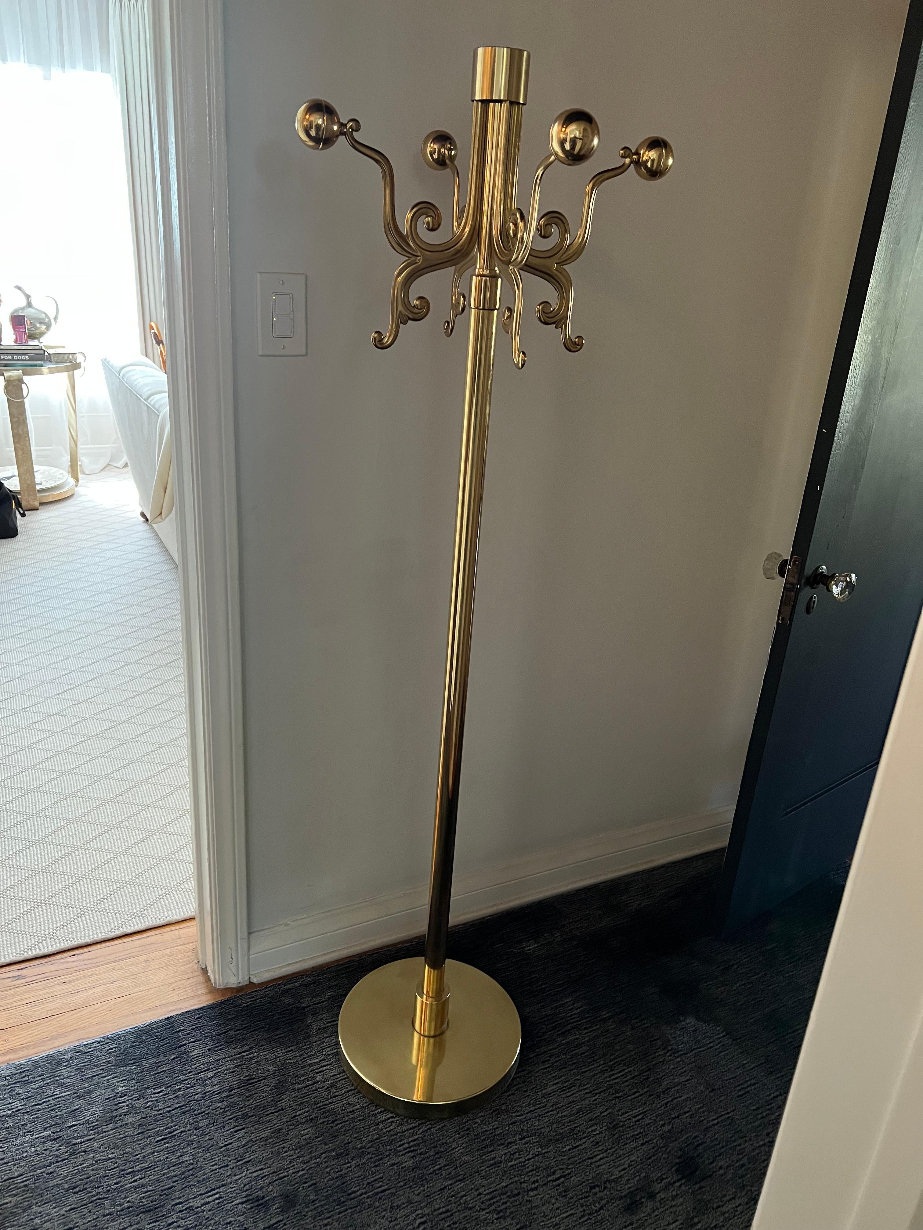 Solid Brass Mid-Century Modern Italian Coat rack or stand. Beautiful Brass with a traditional design brought into a modern look with the design of the arms and spheres at the end of each of the four arms.

The base and shaft are polished brass -