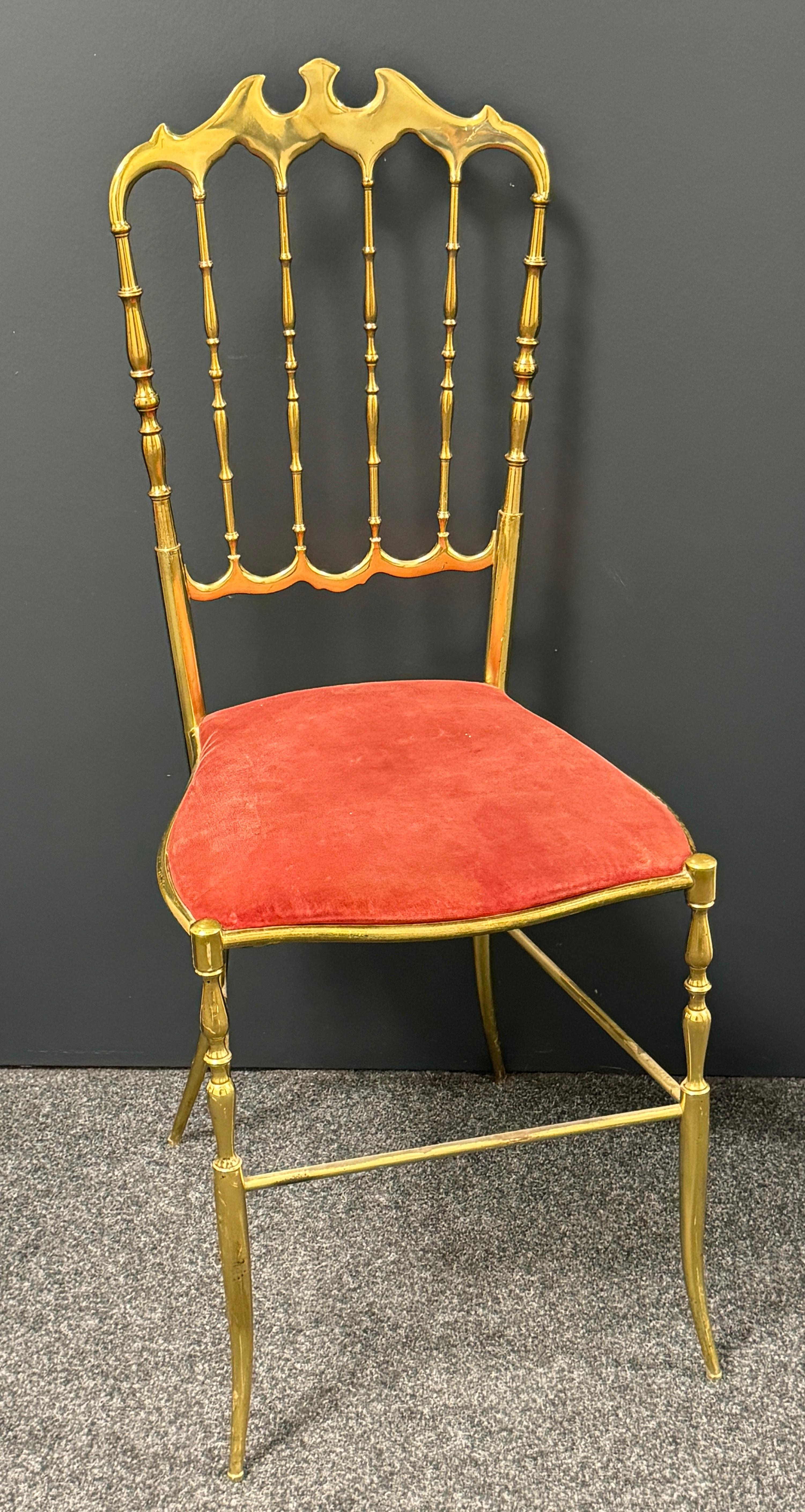 Offered is a solid brass desk chair by Chiavari, circa 1950. It show some minor scratches, also patina and has got the original velvet upholstery. Minor patina gives this pieces a classy statement. Can be reupholstered by the new owner if needed.