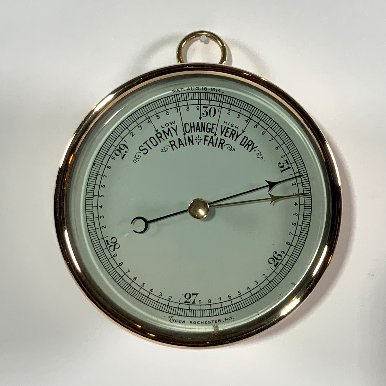 Brass barometer by Taylor of Rochester, NY. Patent date of August 18, 1914. Face is printed 