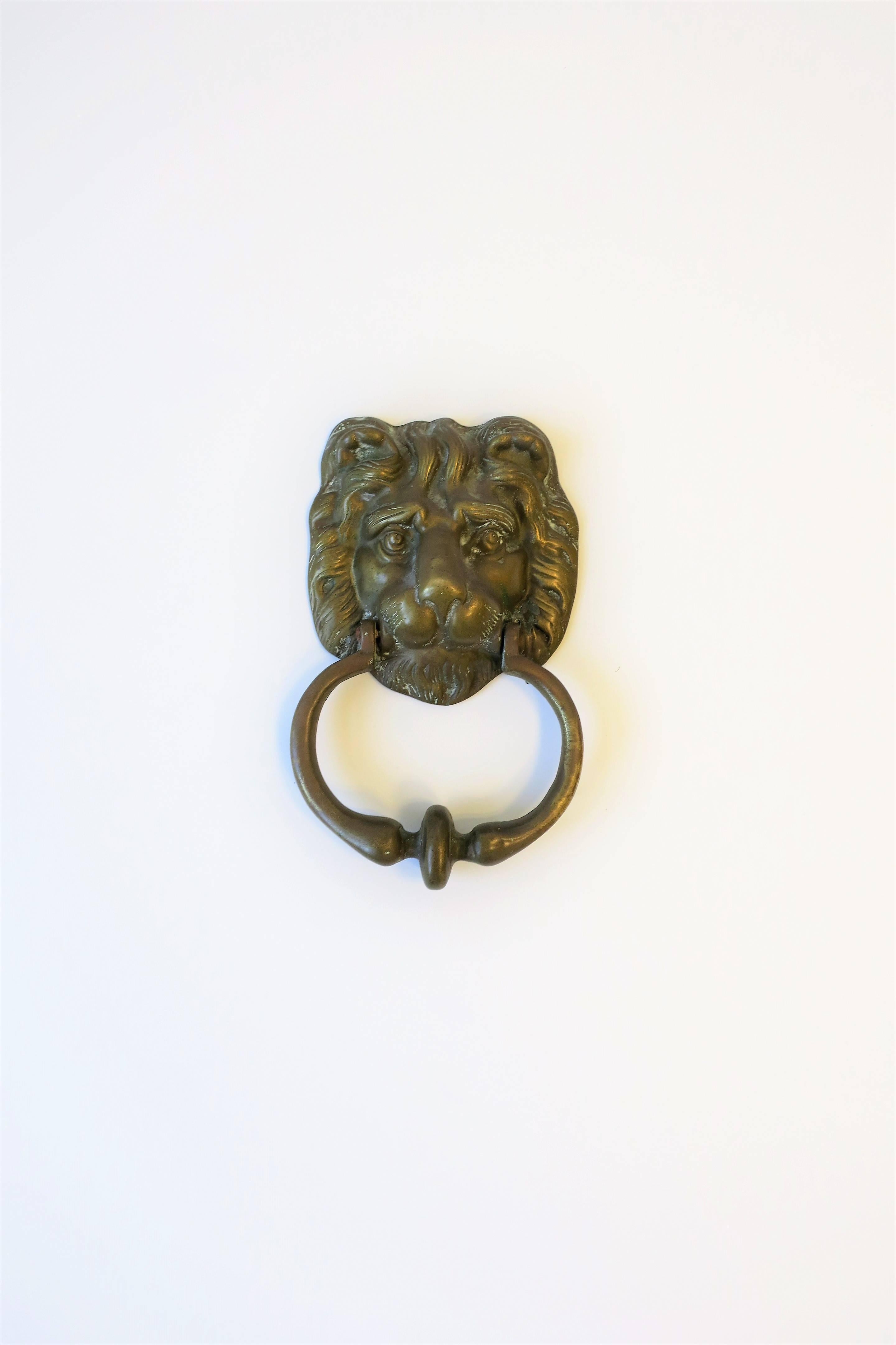 A vintage solid brass lion head door knocker hardware piece in the neoclassical style, circa 20th century, 1970s or later.

Piece measures: 5.50 in. W x 8 in. H.