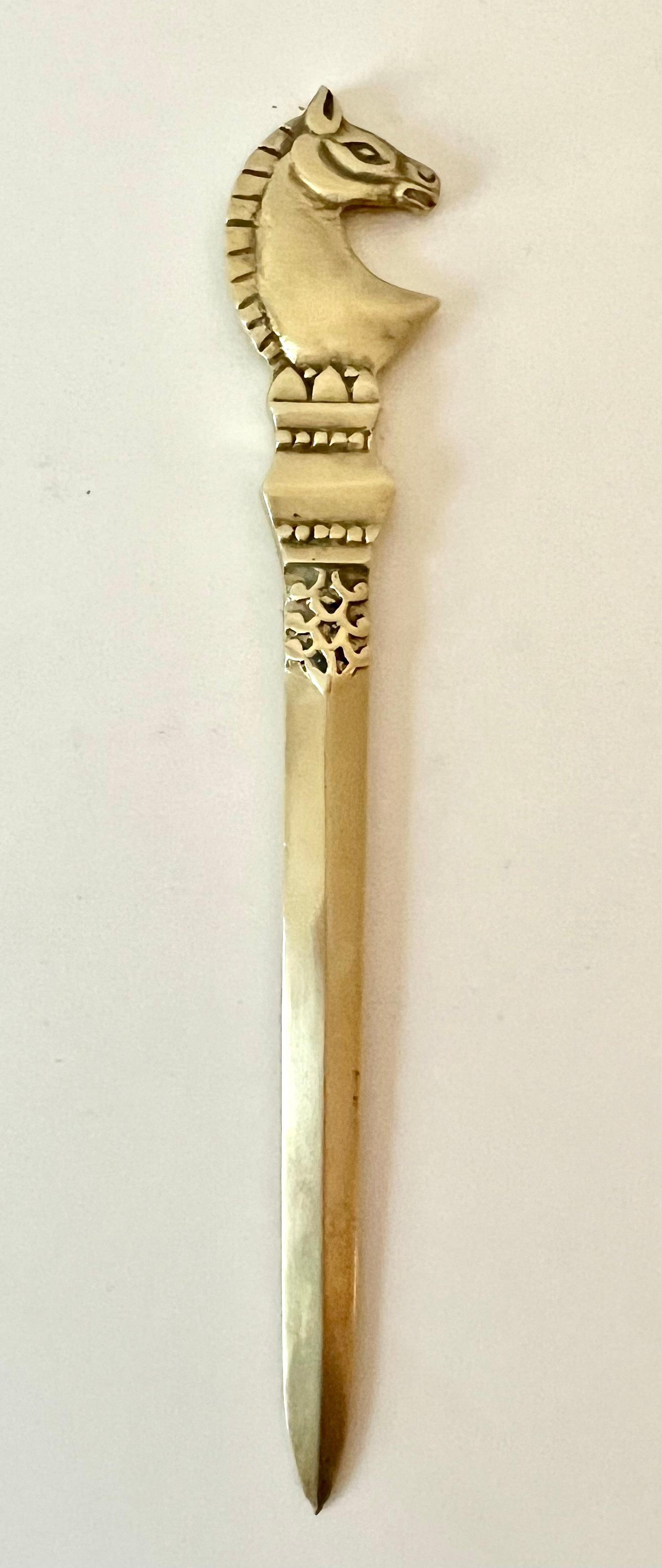 Solid Brass Mid Century Modern Etruscan style horse letter opener.  

A compliment to any desk or work station, and especially those with a MCM twist.  

A beautifully designed piece, when polished to a high gloss it can sparkle, but we love the