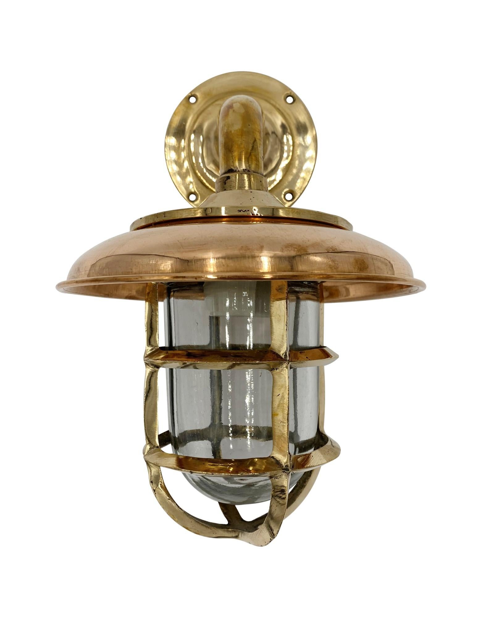 Solid brass 90 degree nautical sconce. Comes with a removable cooper rain shield cover and a glass globe. Takes one standard household light bulb. Small quantity available at time of posting. Please inquire. Priced each. Please note, this item is