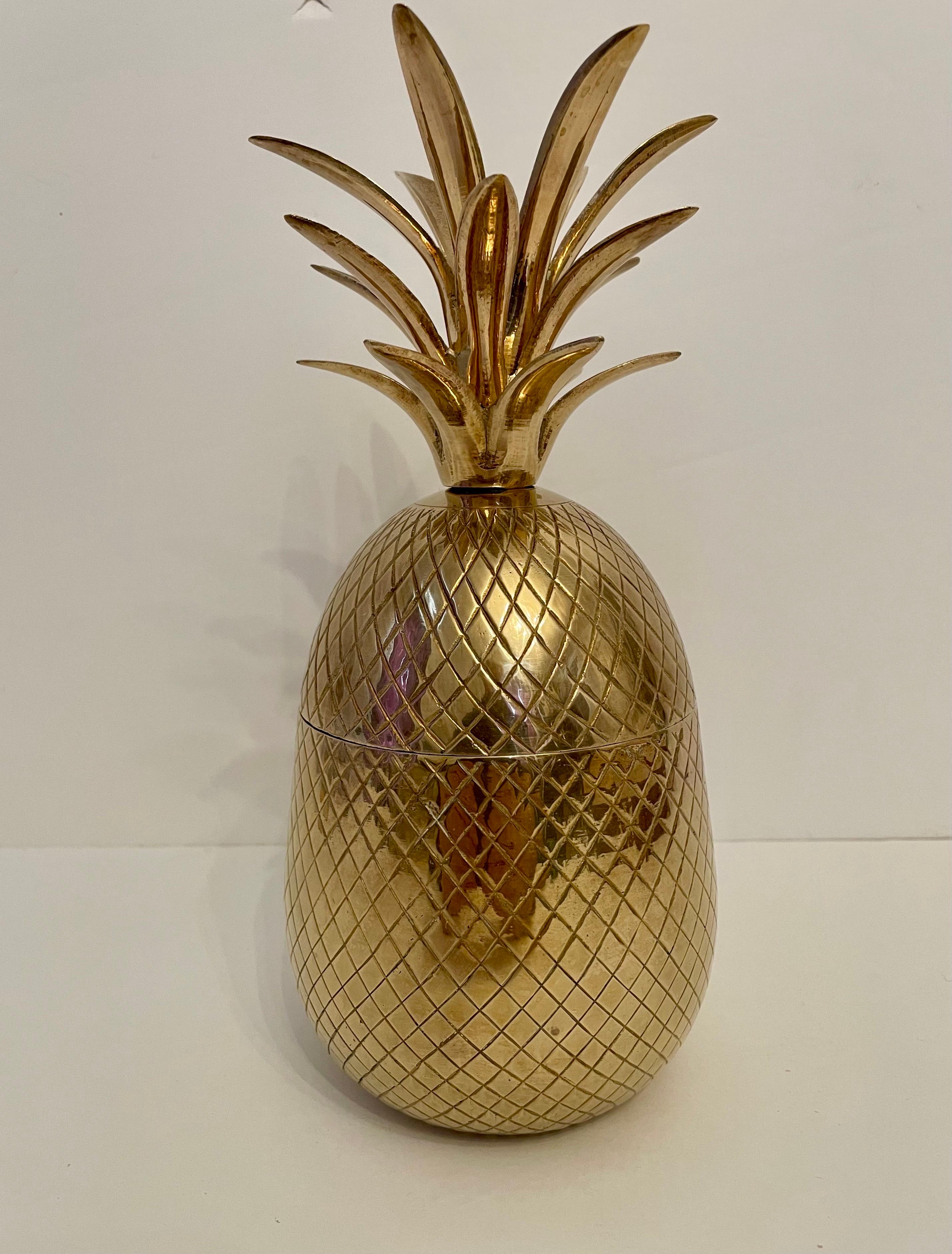 Brass pineapple shaped covered container. Good overall condition. Any dark or light areas in photos is reflection. Hand polished. Measures: 10” tall x 4.5” diameter