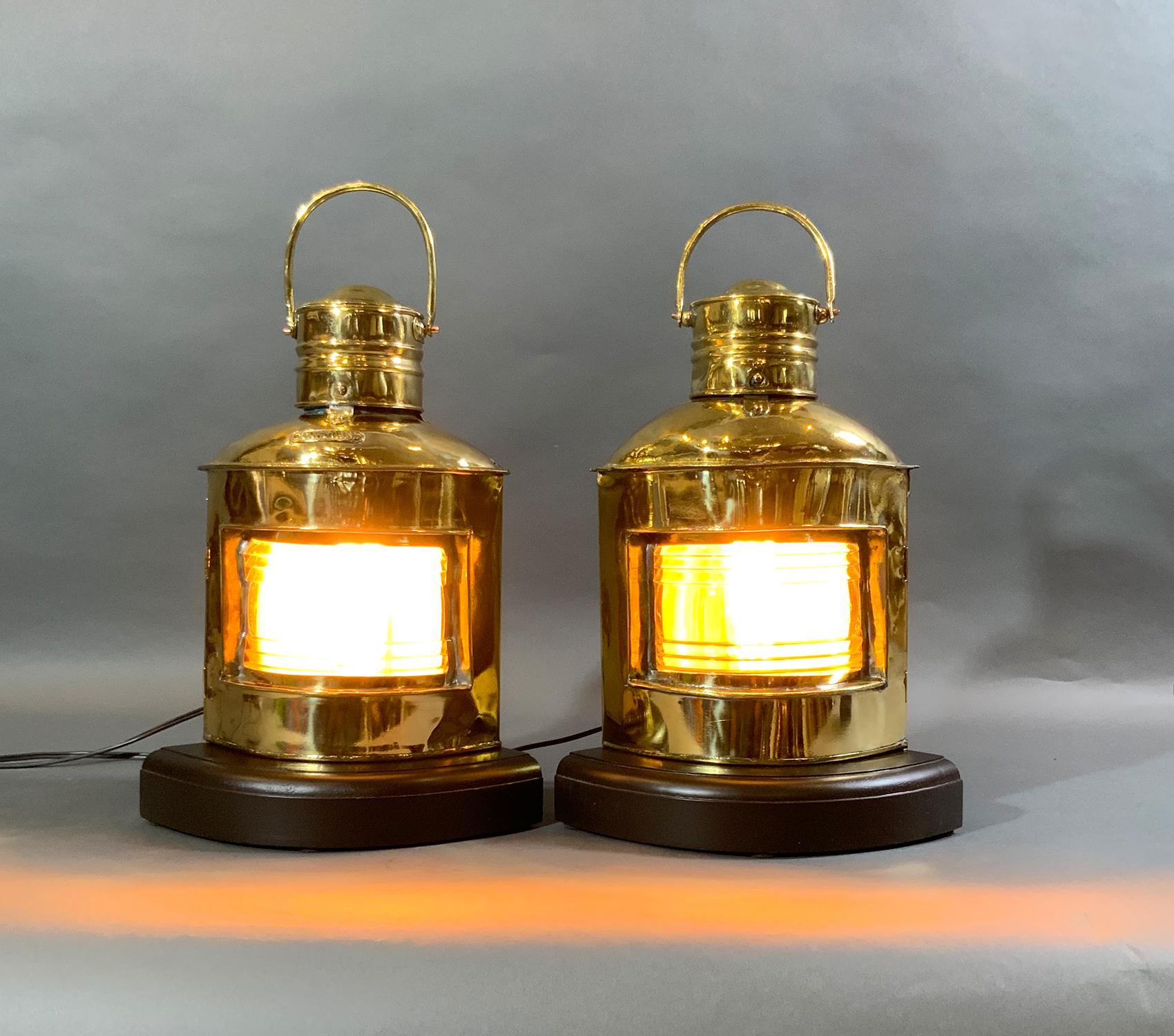 Highly polished and lacquered solid brass ships lantern with clear glass lenses. Lacking colored red and green filters. Mounted to thick mahogany bases. Wire with new sockets and cords.

Weight: 6 LBS
Overall Dimensions: 15” H x 11” L x 9”
