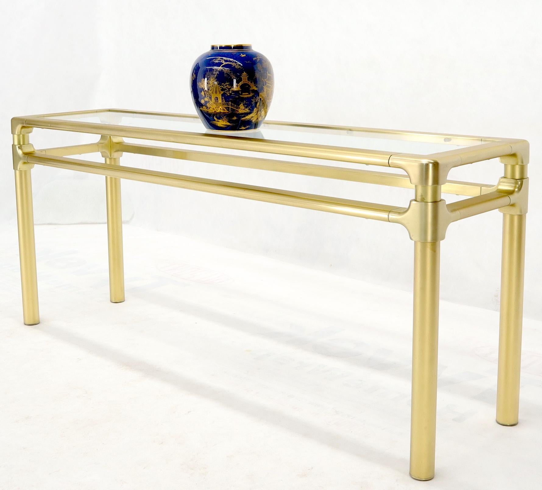 Mid-Century Modern solid brass profile base glass top console or sofa table. In style of Mastercraft.